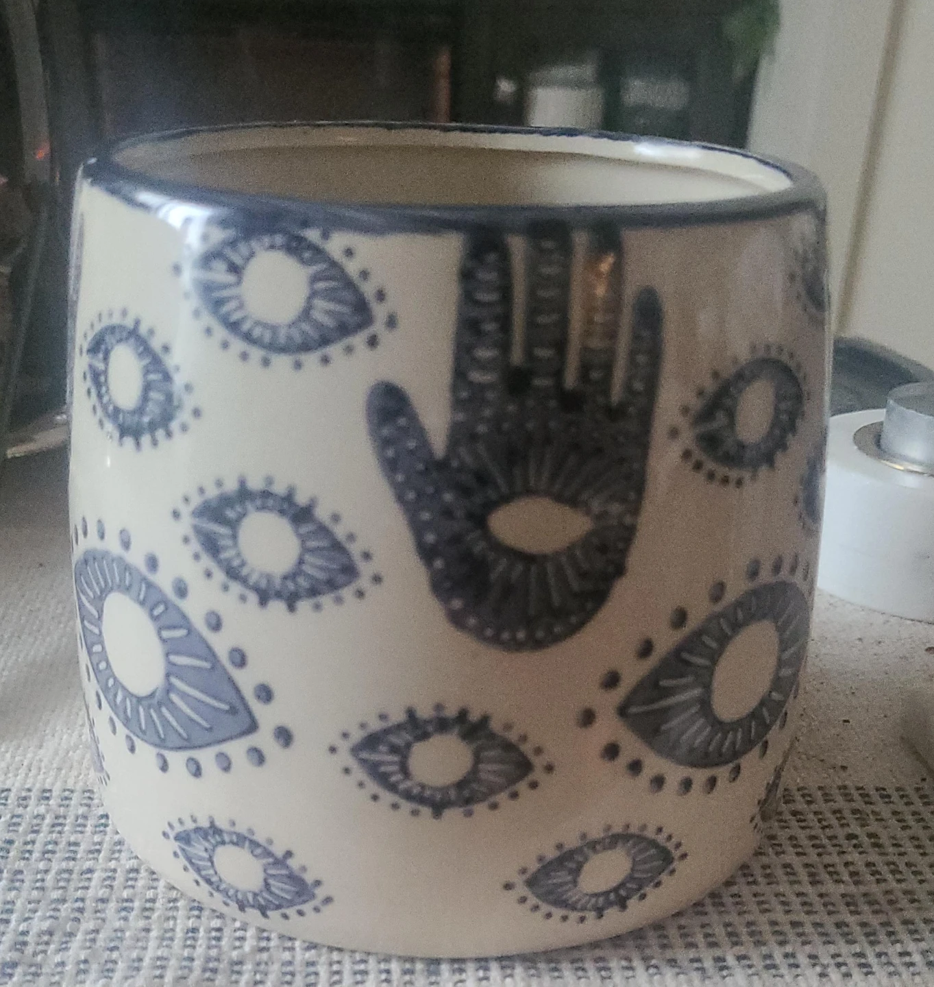 Ceramic pot with eye and hand design