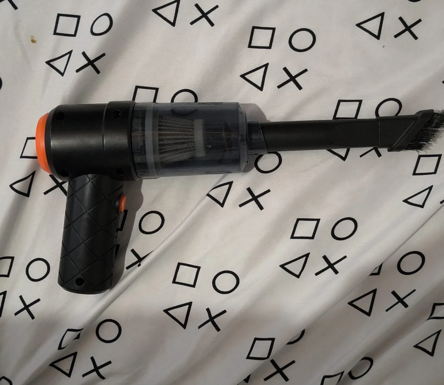 Black Handheld Mini Vacuum Cleaner with Orange Accent