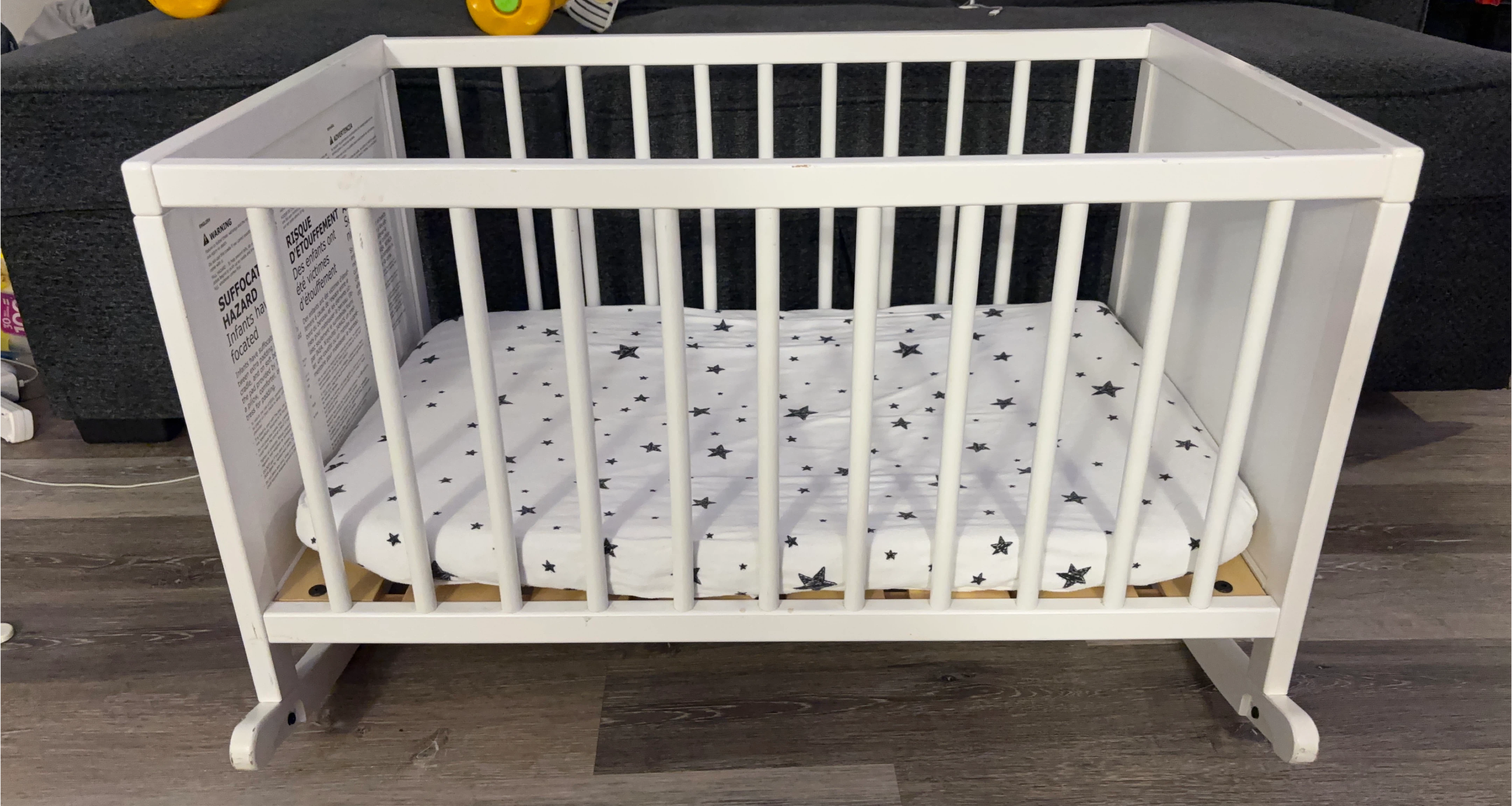 White Baby Crib with Star Print Mattress Cover