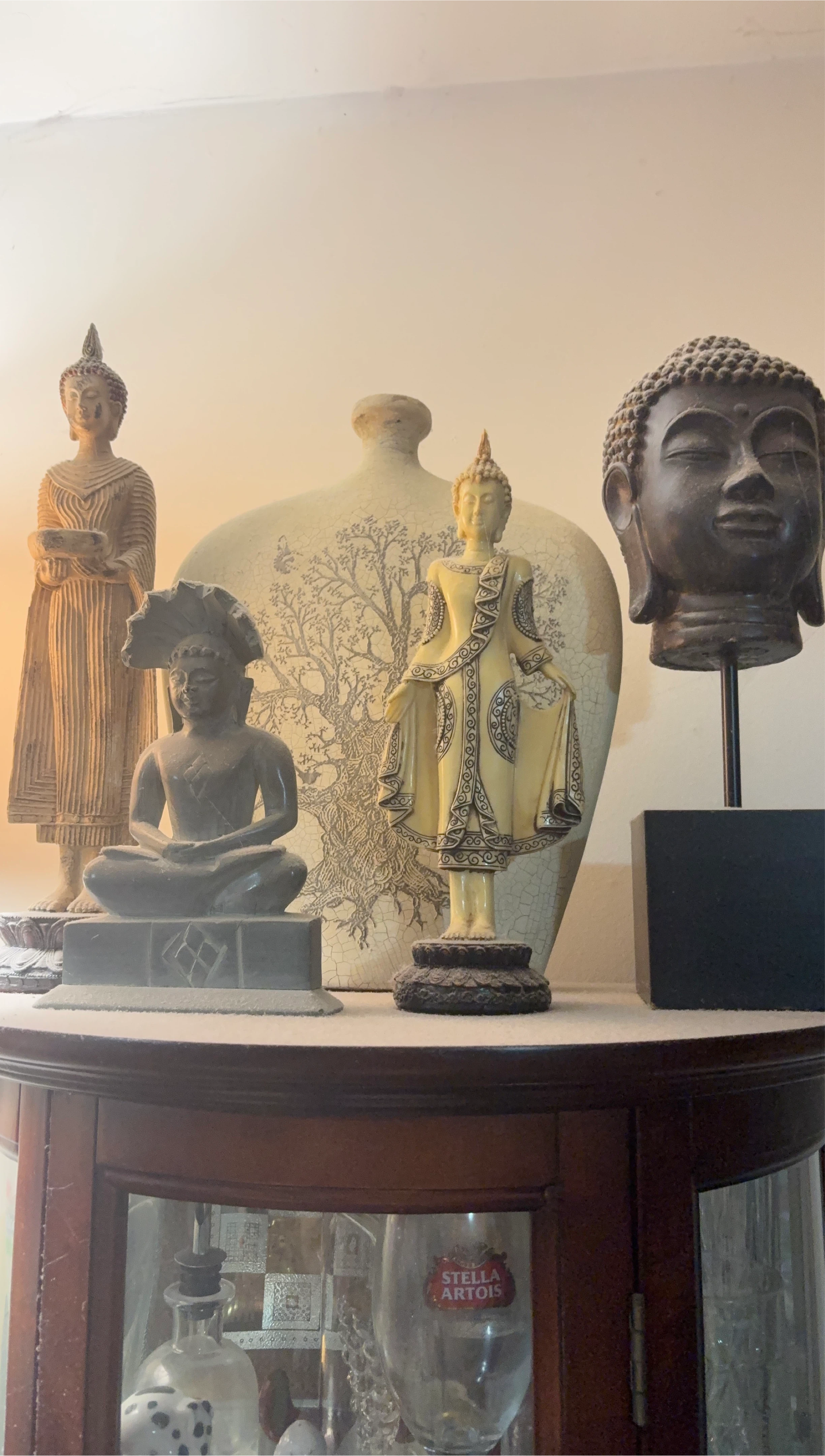 Collection of Buddha Statues and Vase