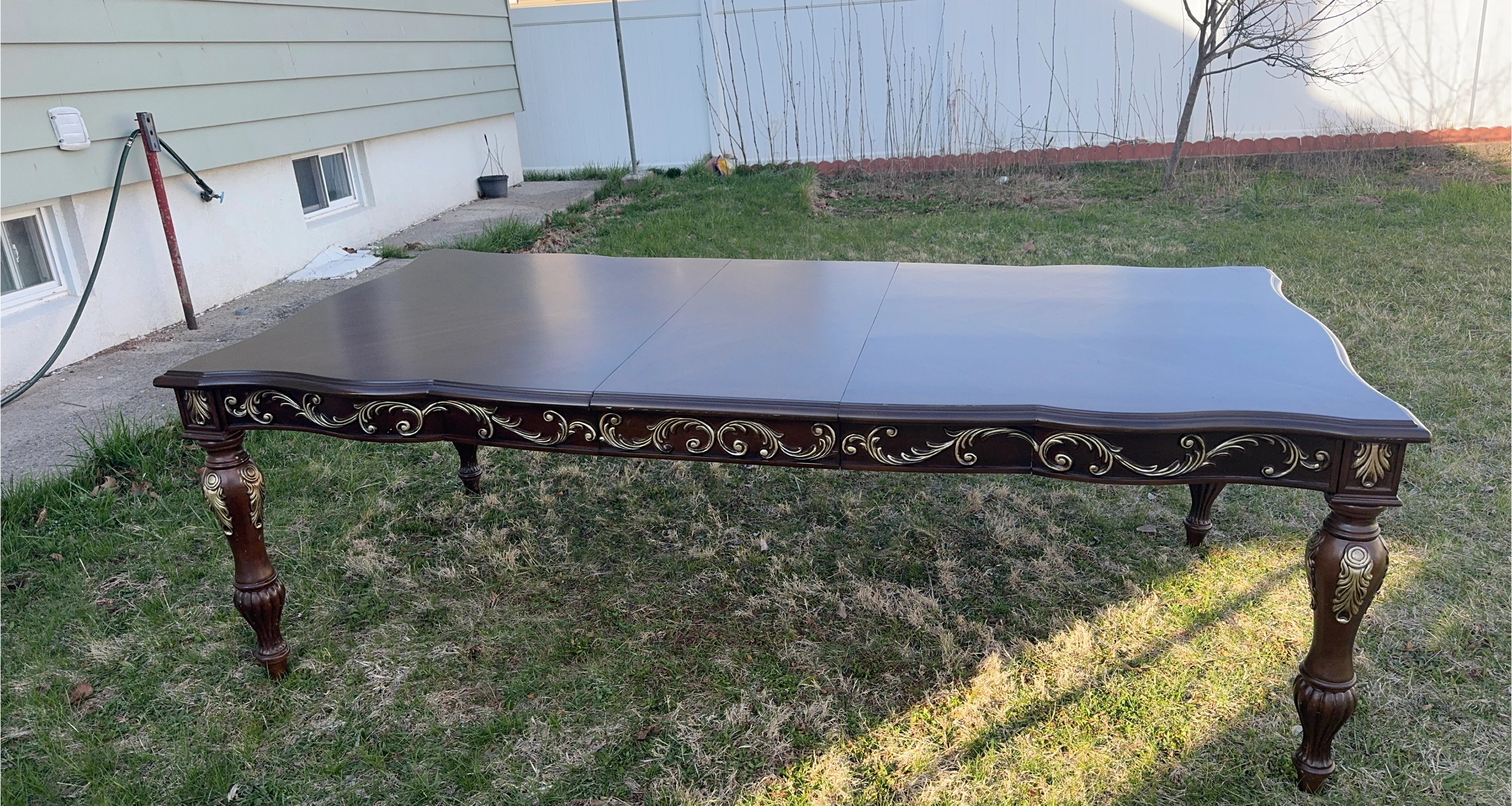 Dark Wood Dining Table with Ornate Gold Accents