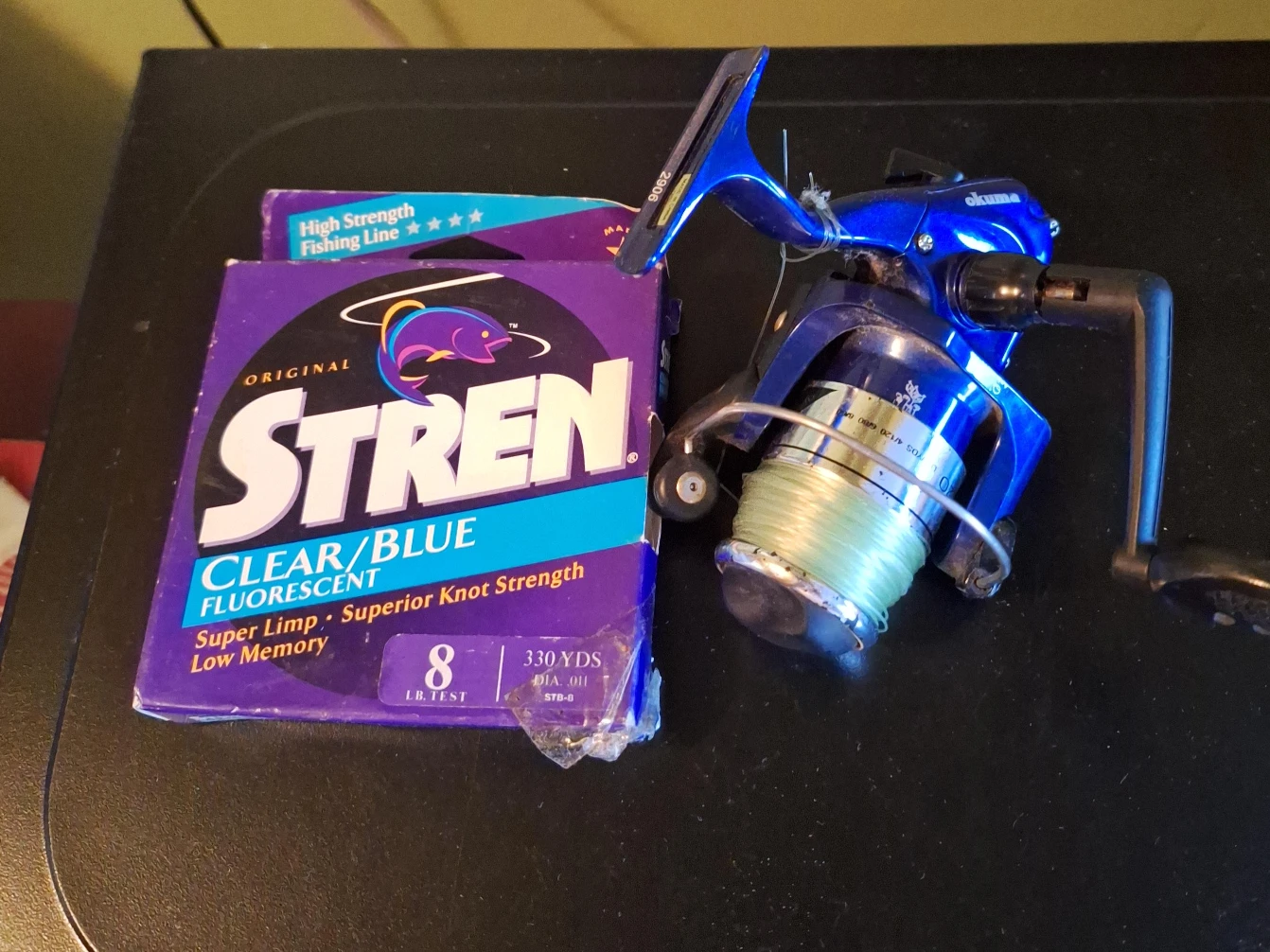 Okuma Fishing Reel with Stren Clear/Blue Fluorescent Line