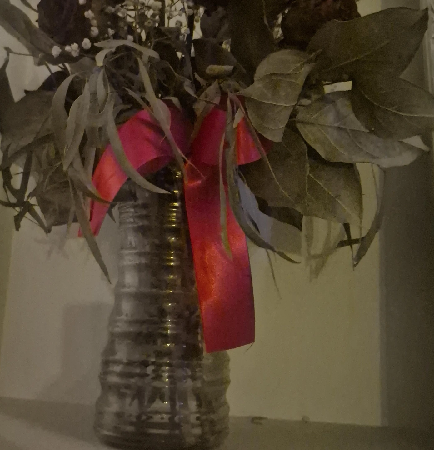 Dried floral arrangement in decorative vase