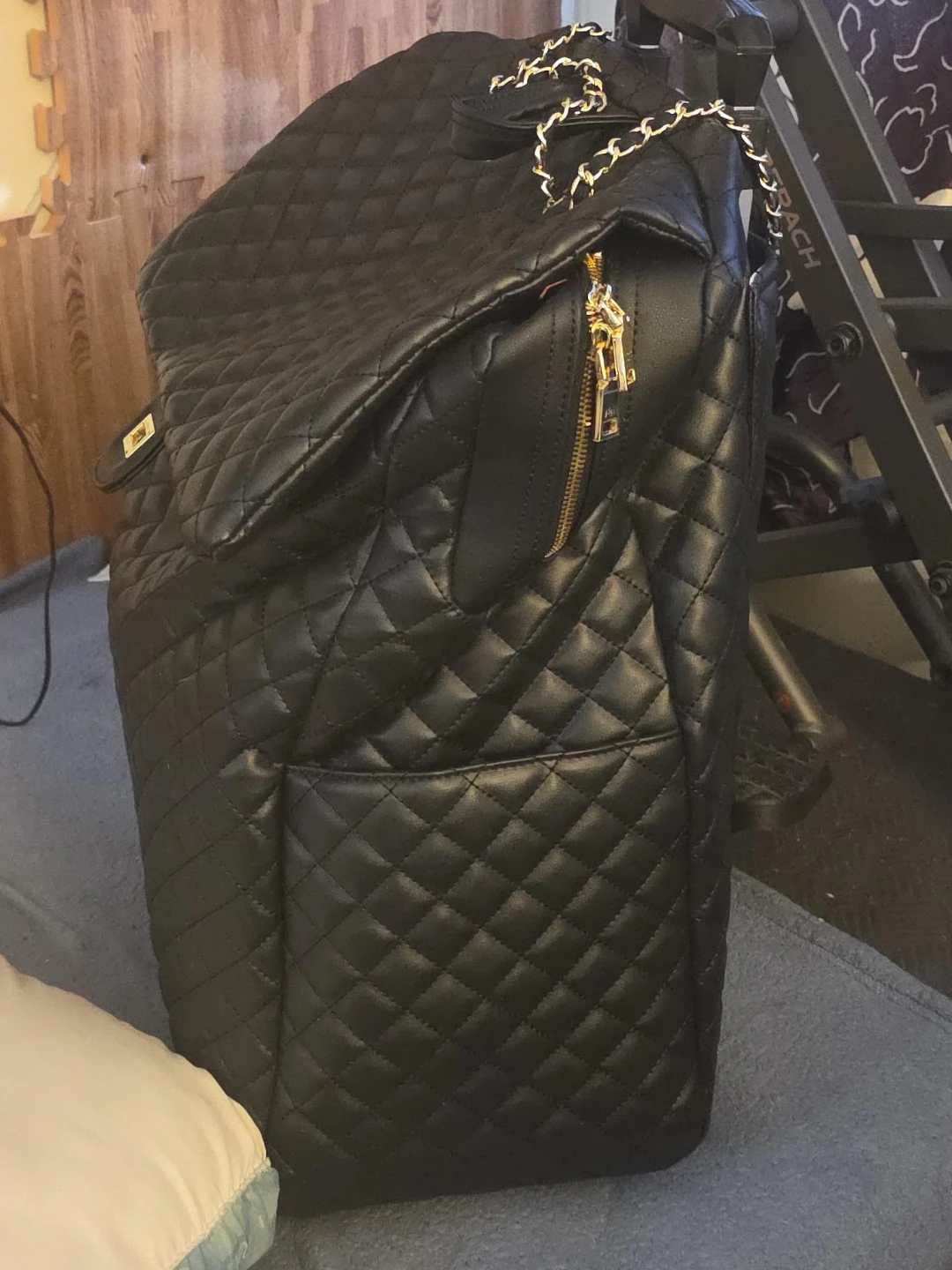 Black Quilted Rolling Backpack with Gold Chain
