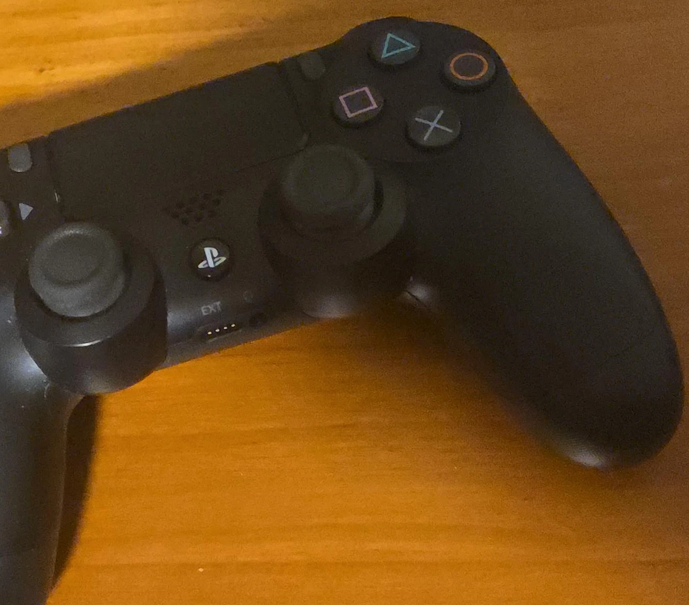 Black PlayStation DualShock 4 Controller with charger cord