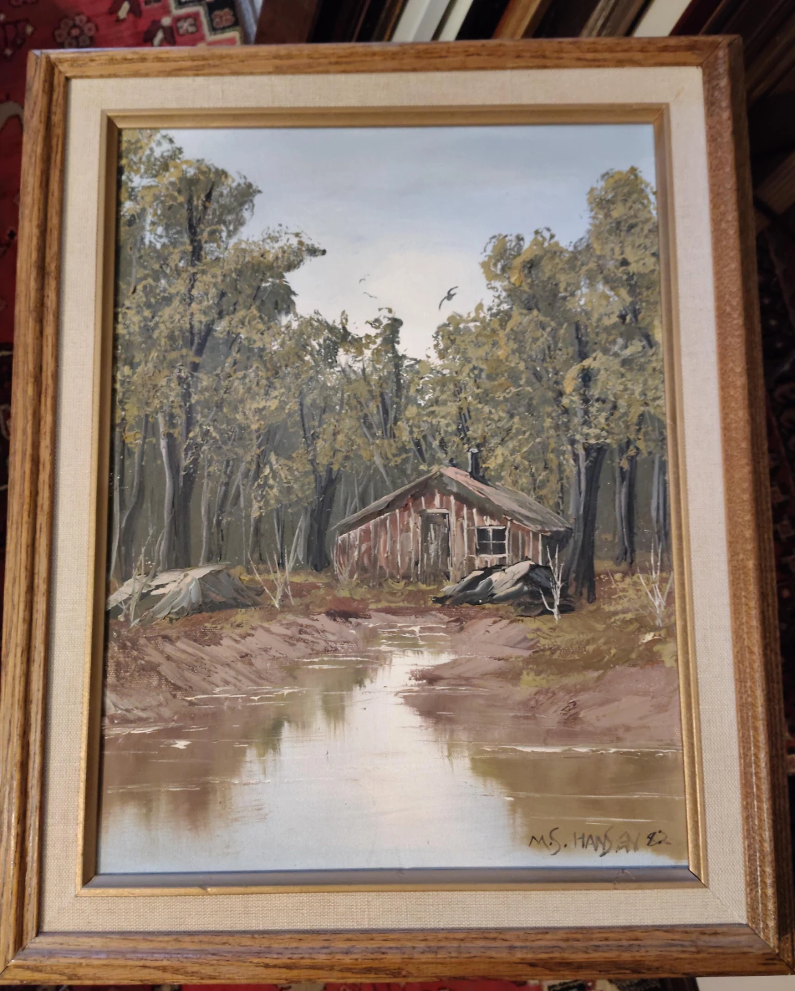 Framed Landscape Painting of Cabin by Water