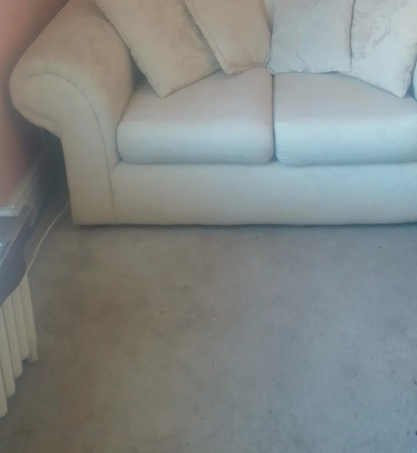 Cream coloured sofa with throw pillows