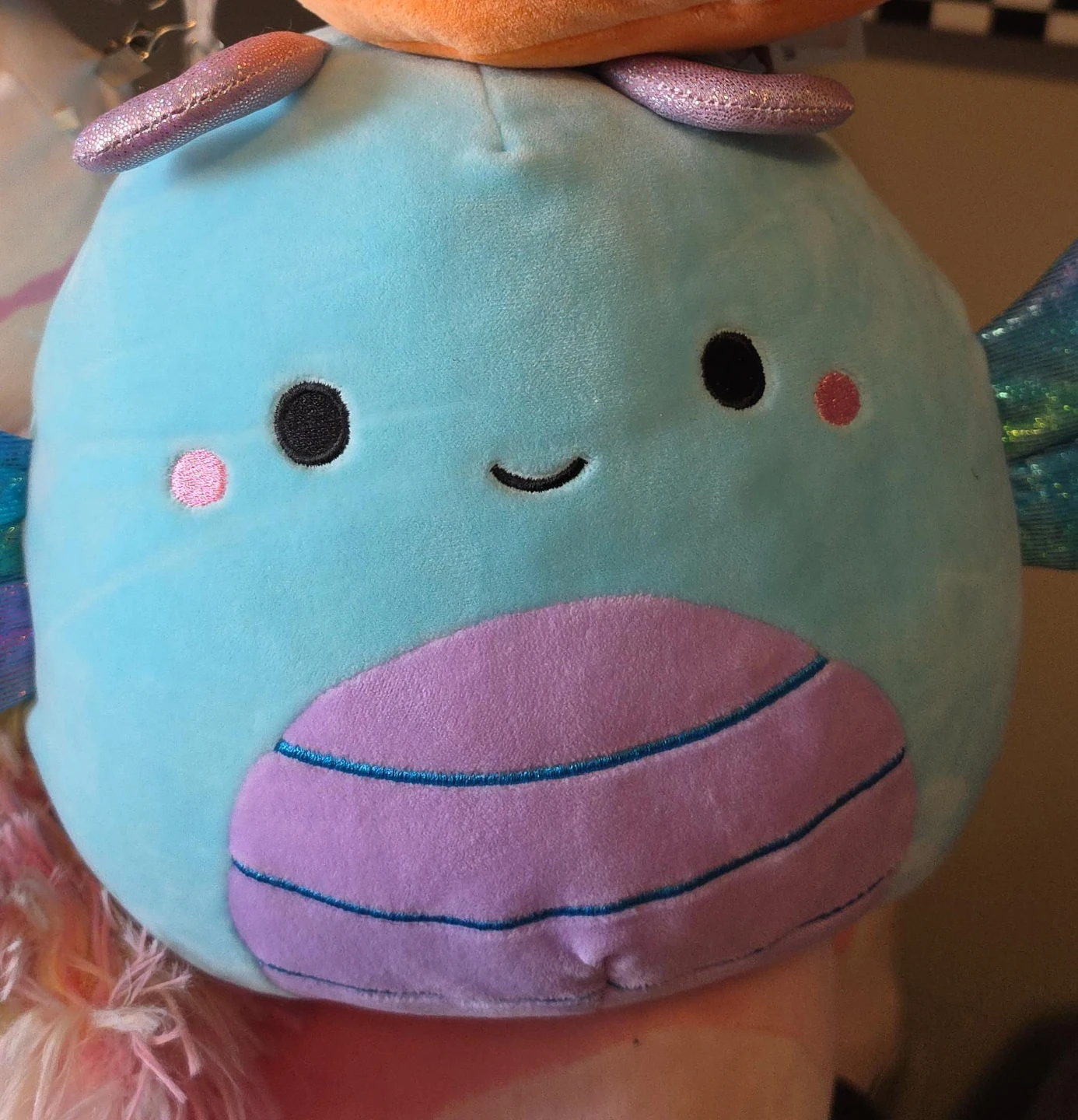 Blue plush dragon with iridescent wings
