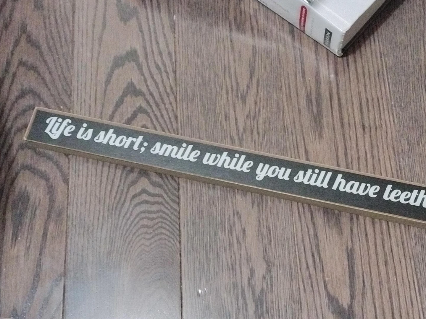 Wooden 'Life is short; smile while you still have teeth' Sign