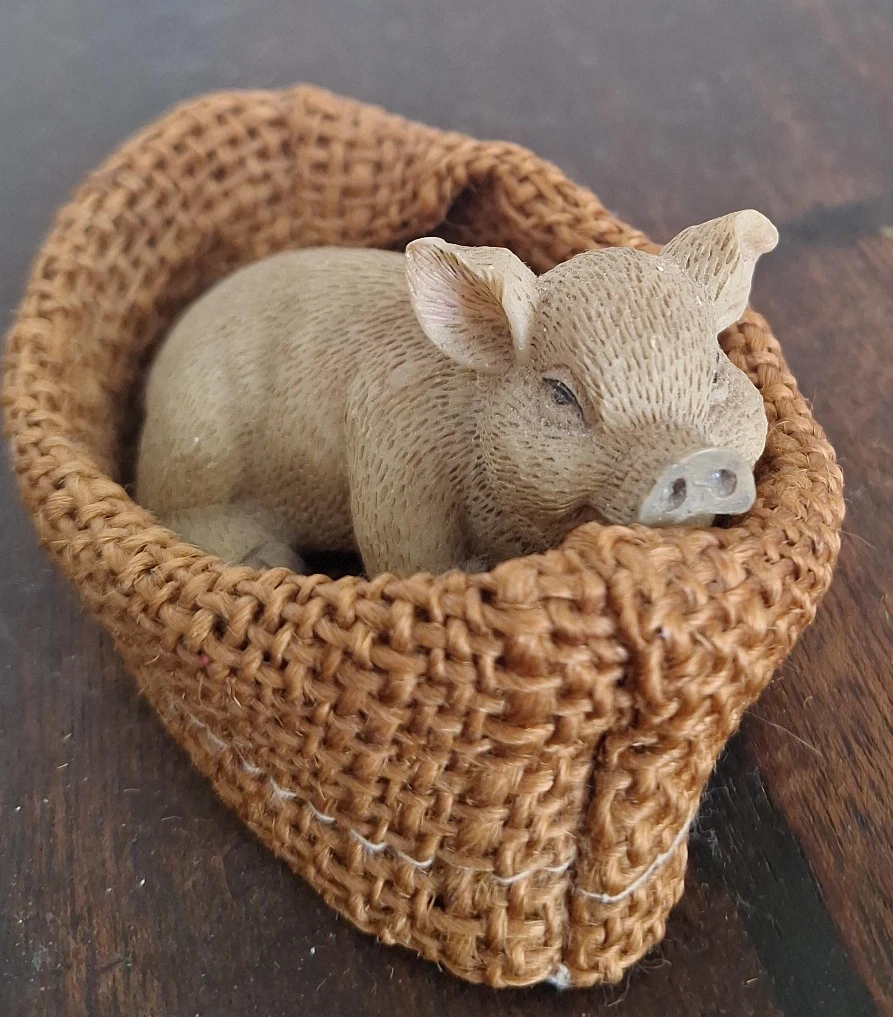 Sleeping Pig Figurine in Woven Basket
