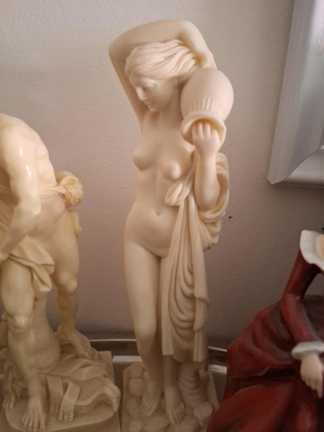 Cream coloured figurine of a woman with a jug