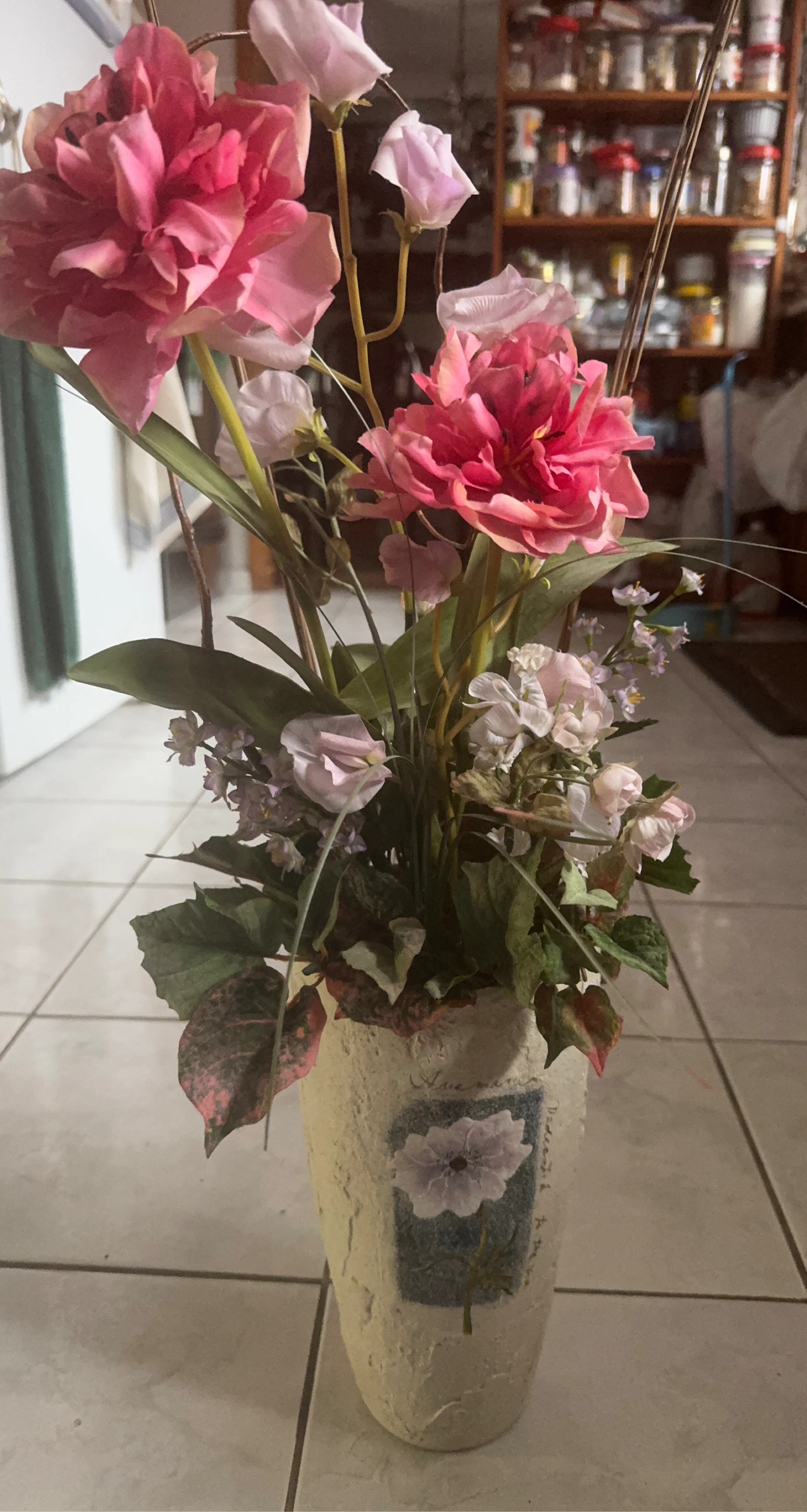 Faux floral arrangement in decorative vase