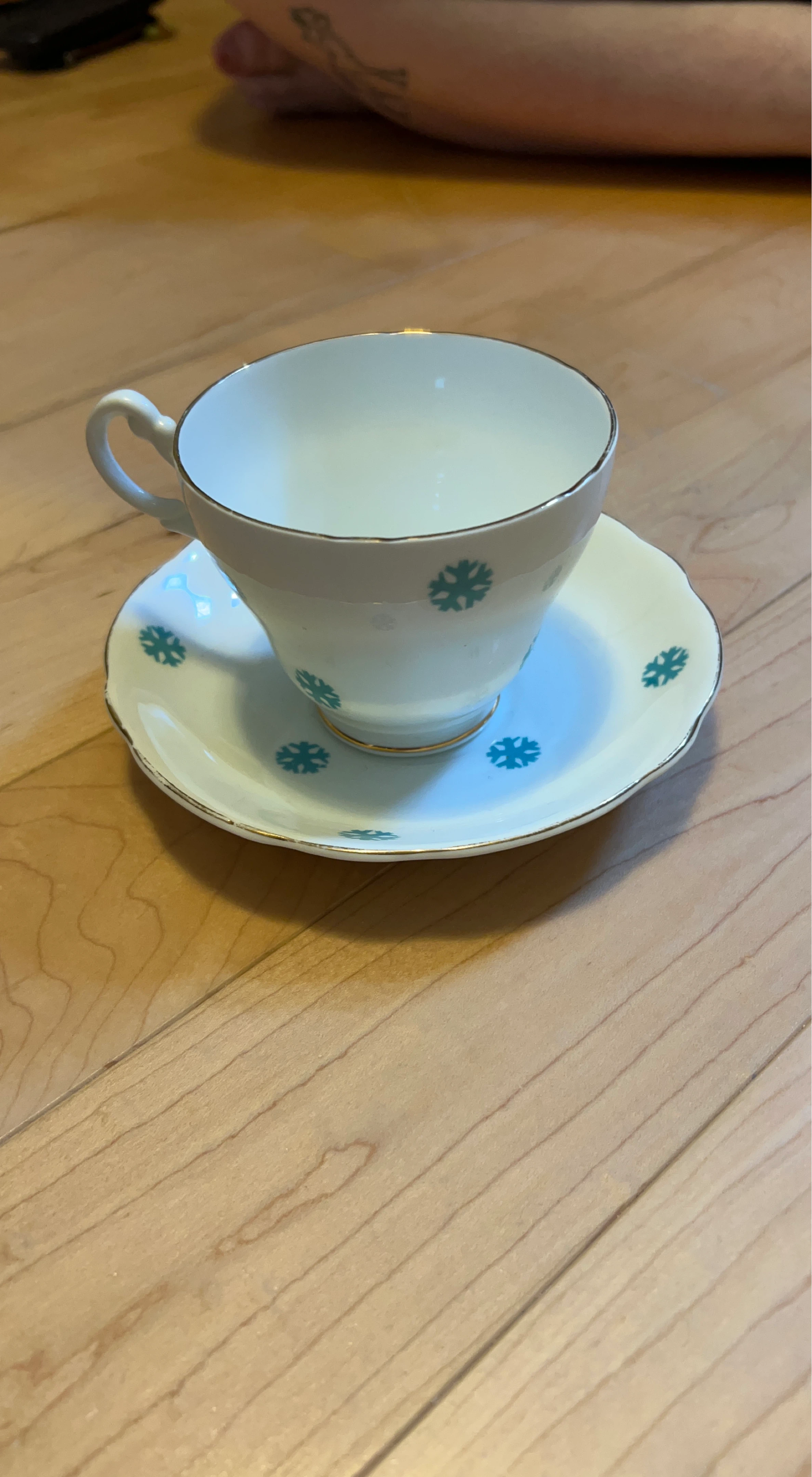 White Teacup and Saucer Set with Blue Snowflake Design