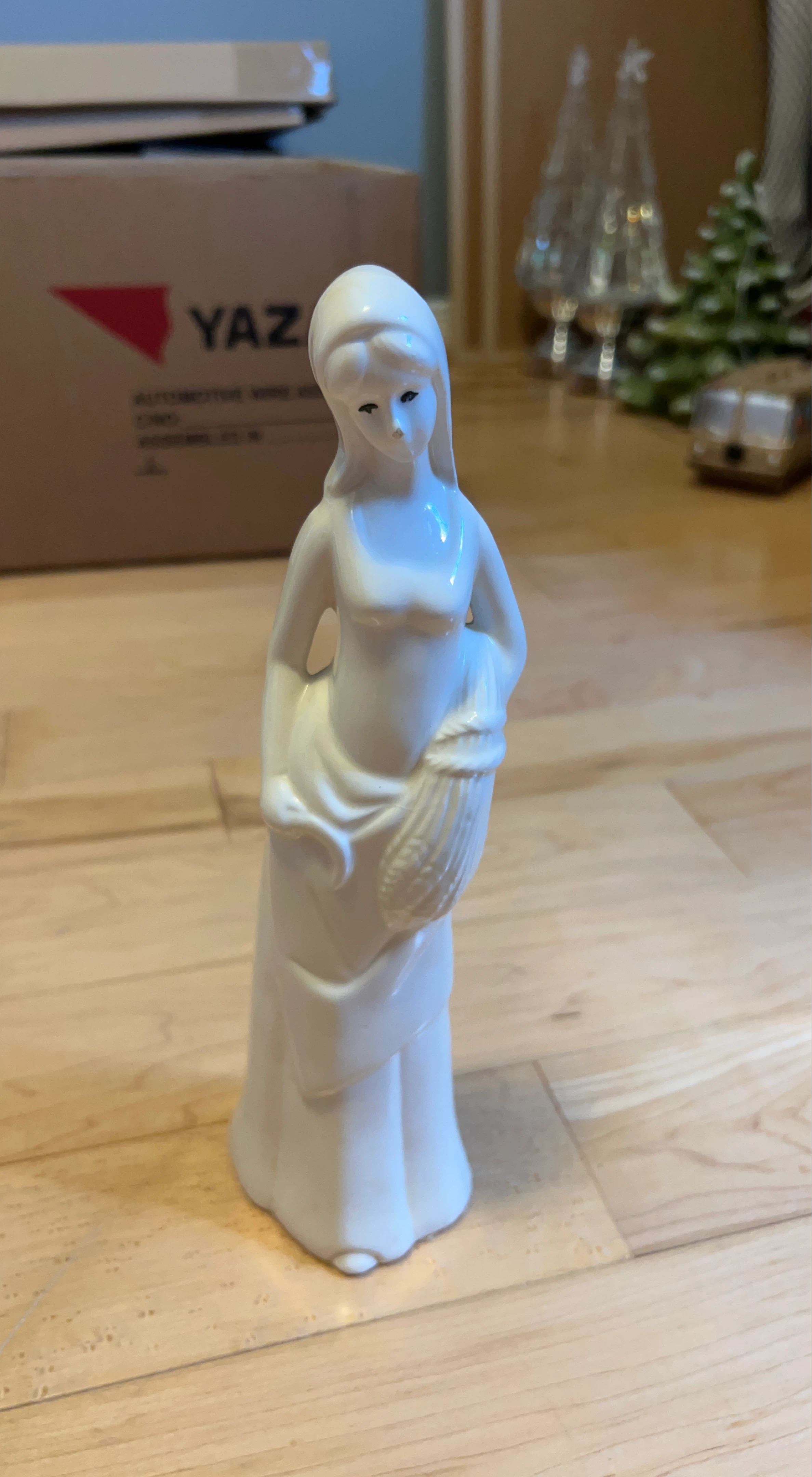 White Ceramic Figurine of a Woman Holding Corn