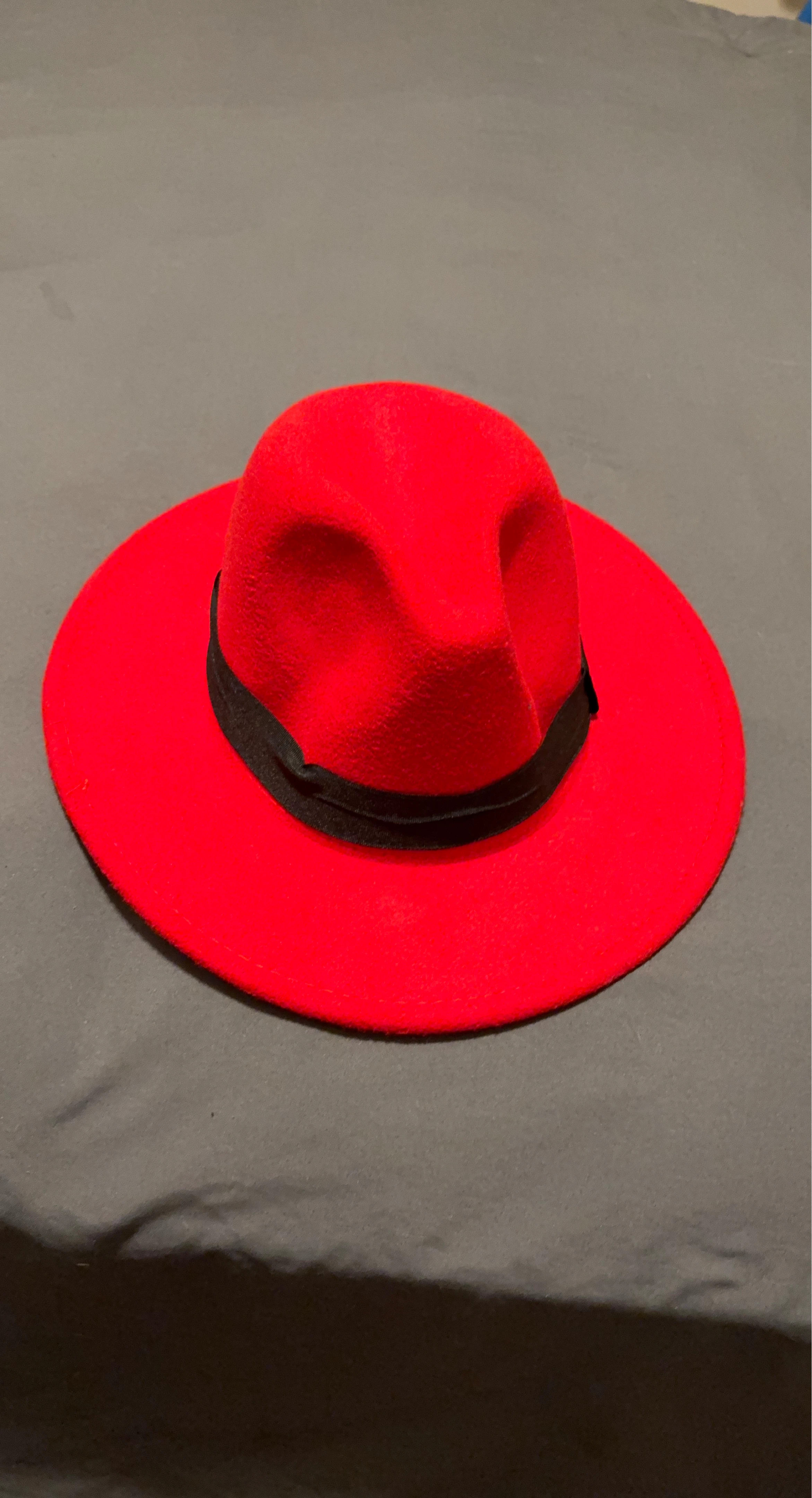 Red fedora hat with black band