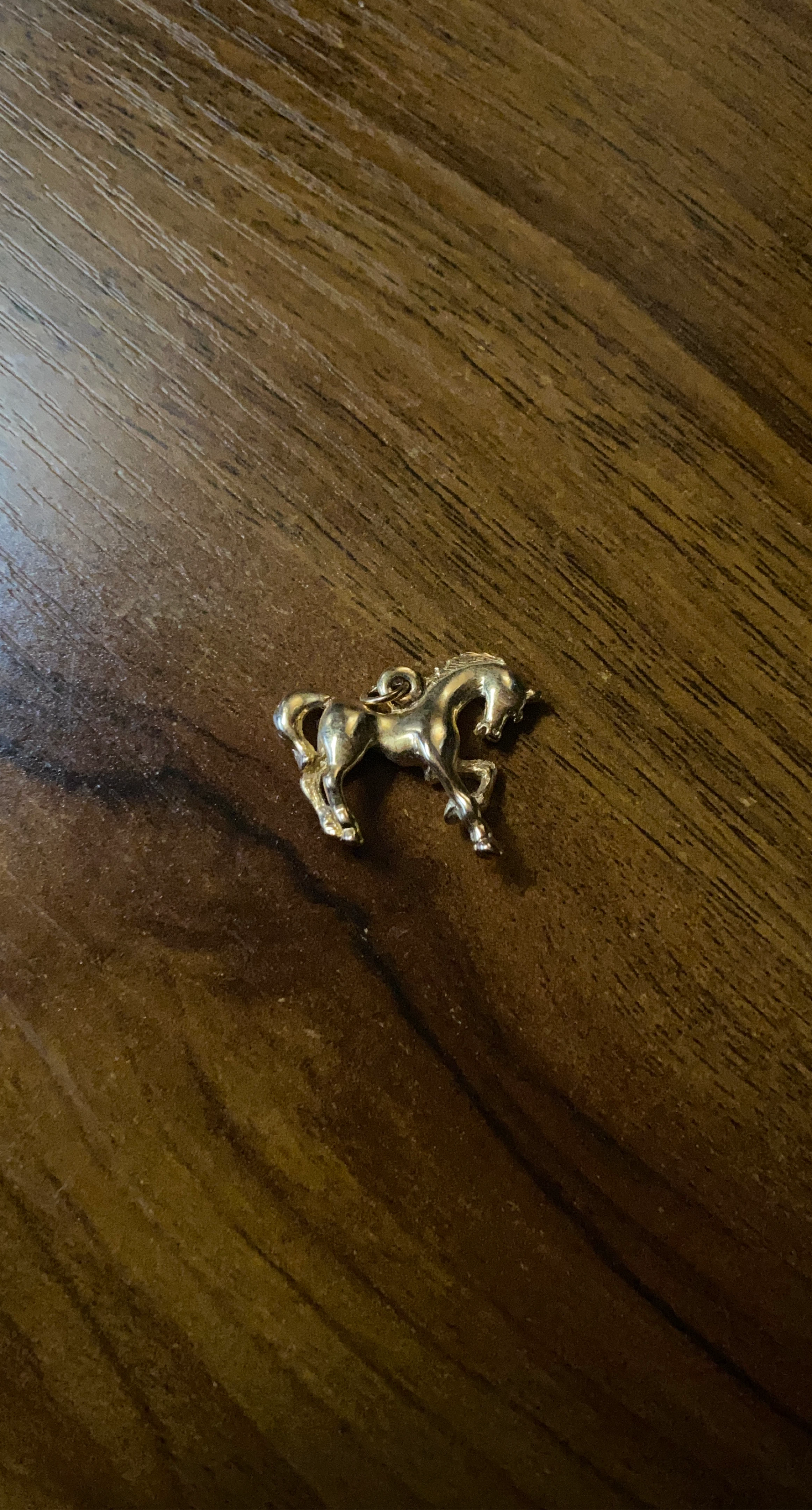 Gold coloured horse charm pendant