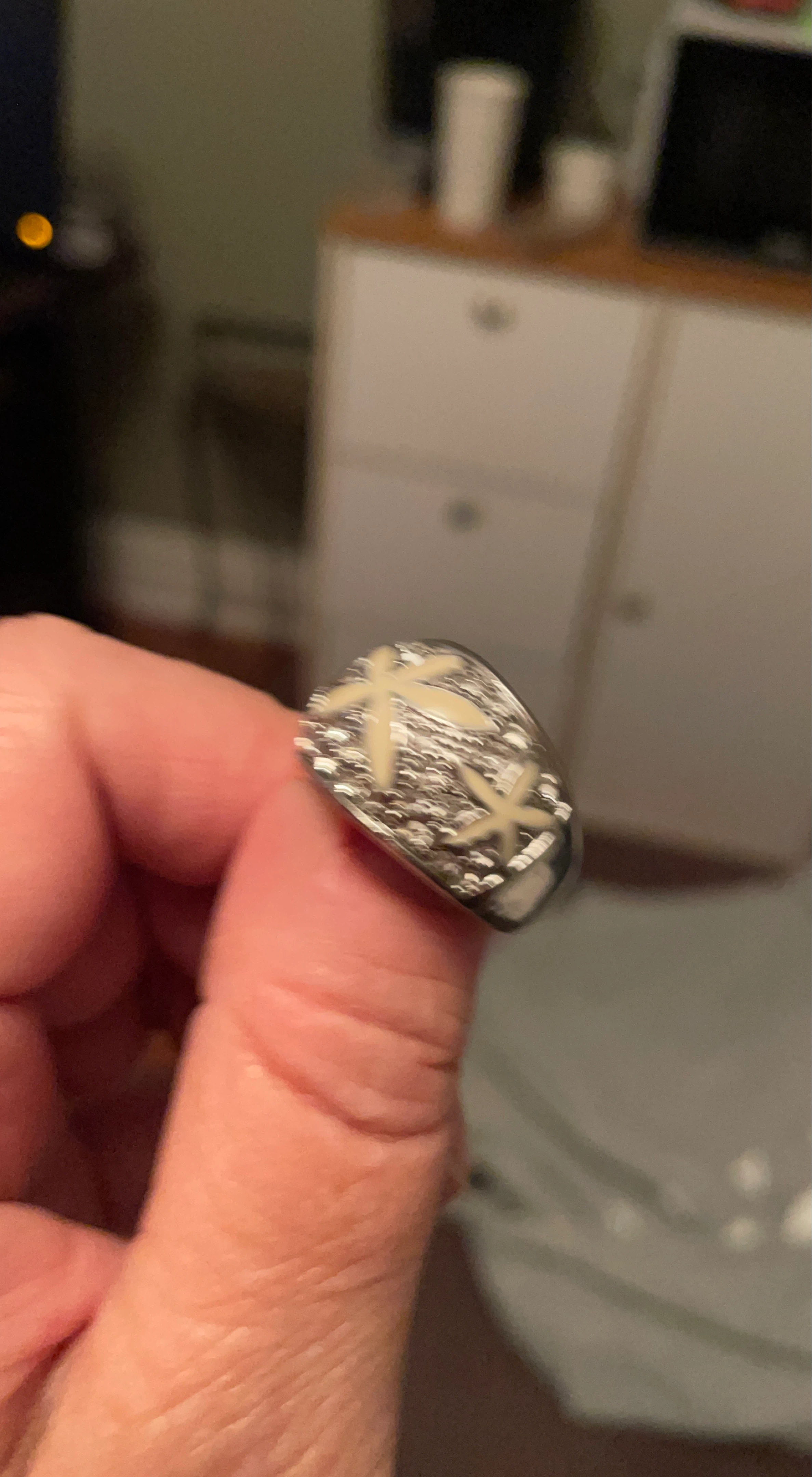 Silver-tone ring with embossed cross pattern