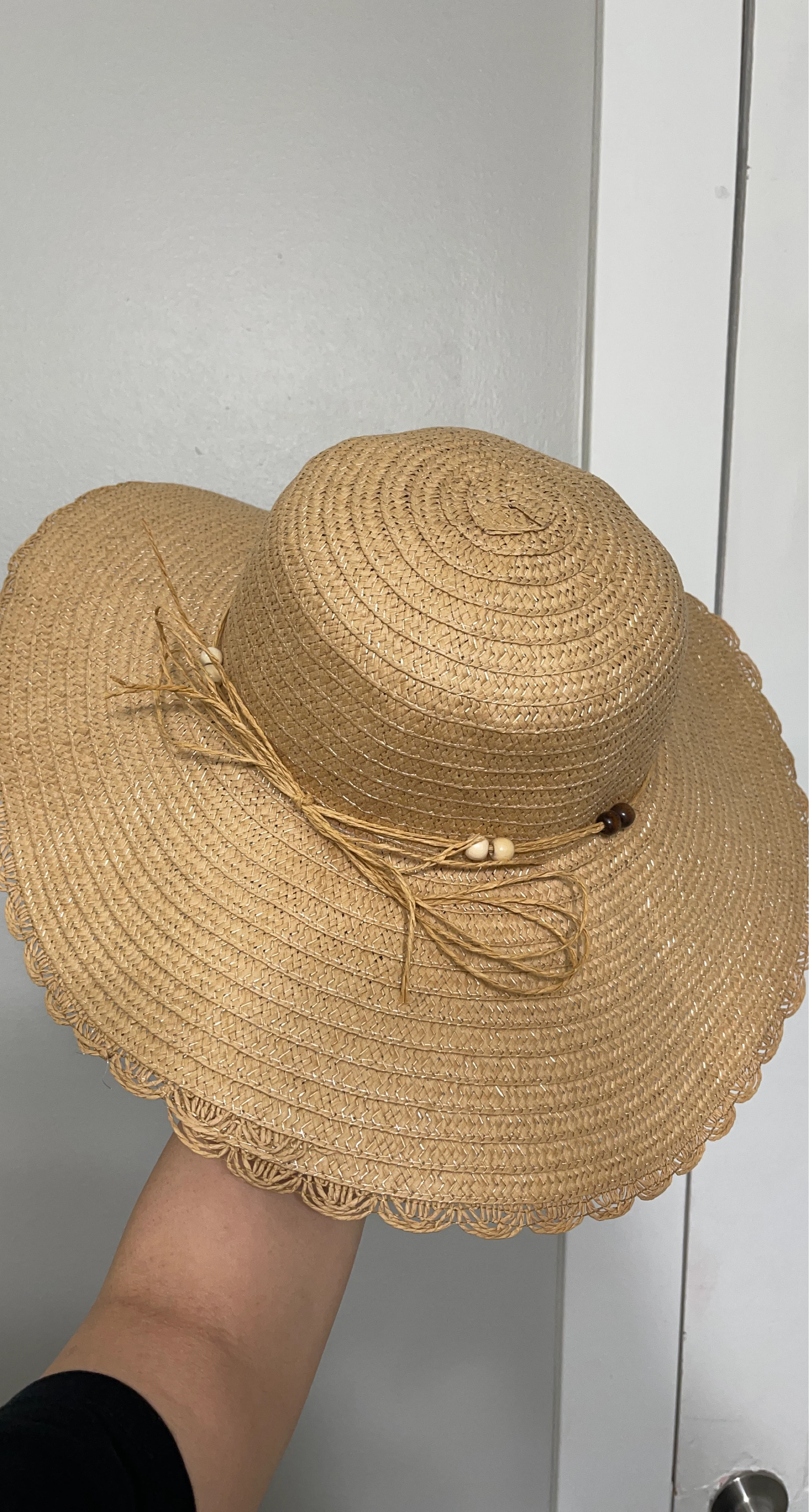 Straw sun hat with decorative beads and raffia tie