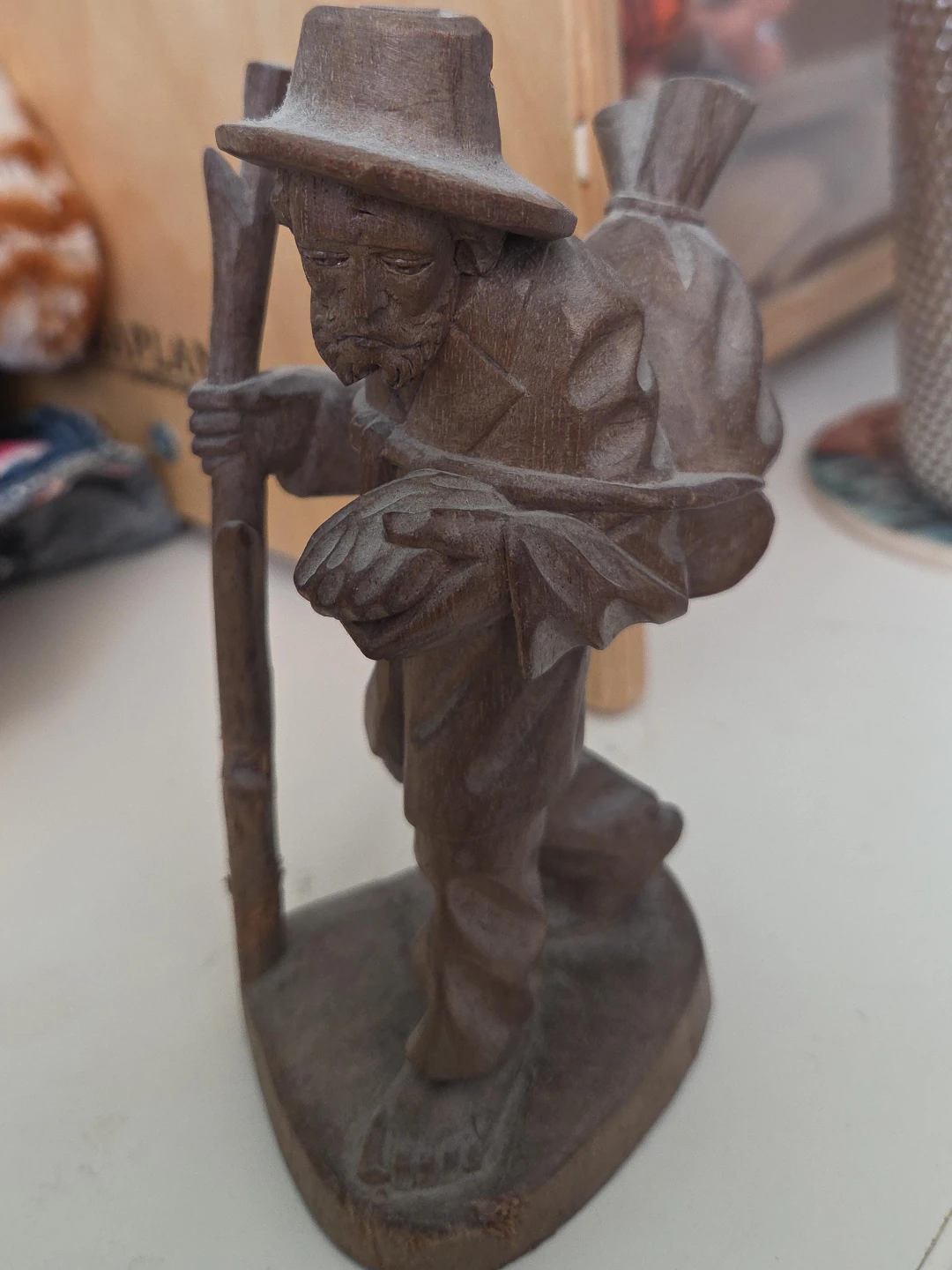 Carved Wooden Figurine of a Traveler with a Hat and Backpack