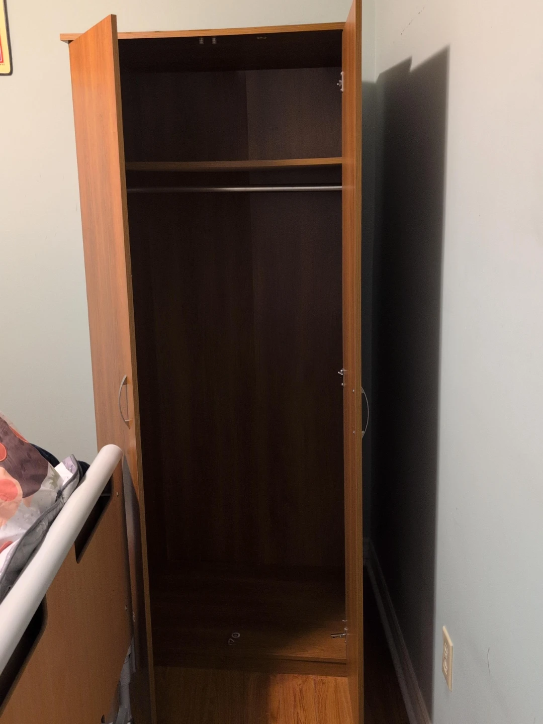 Wooden wardrobe with hanging rail