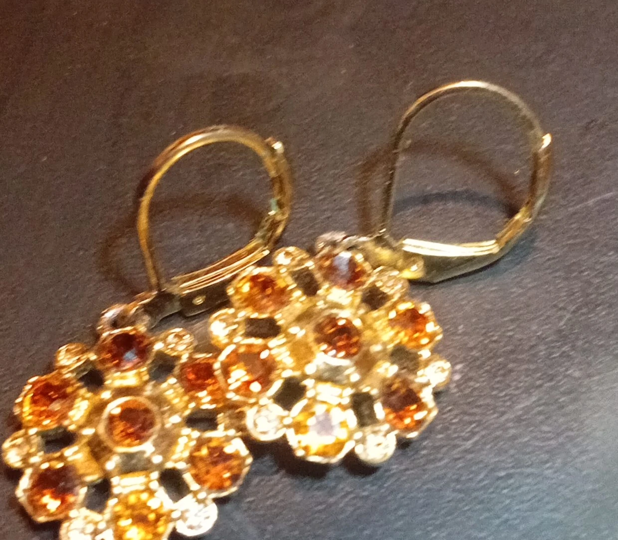 Gold tone cluster earrings with amber and clear stones
