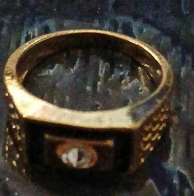 Gold-tone ring with black enamel inlay