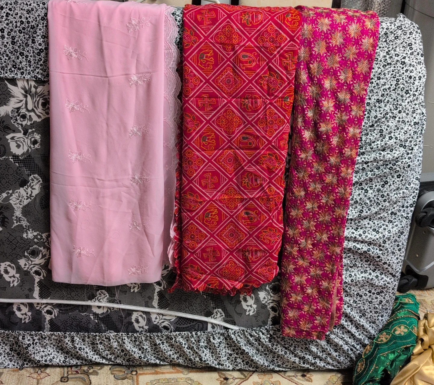 Pink embroidered fabric and two patterned fabrics dappta