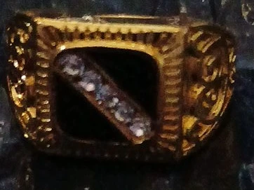 Gold-tone ring with stones