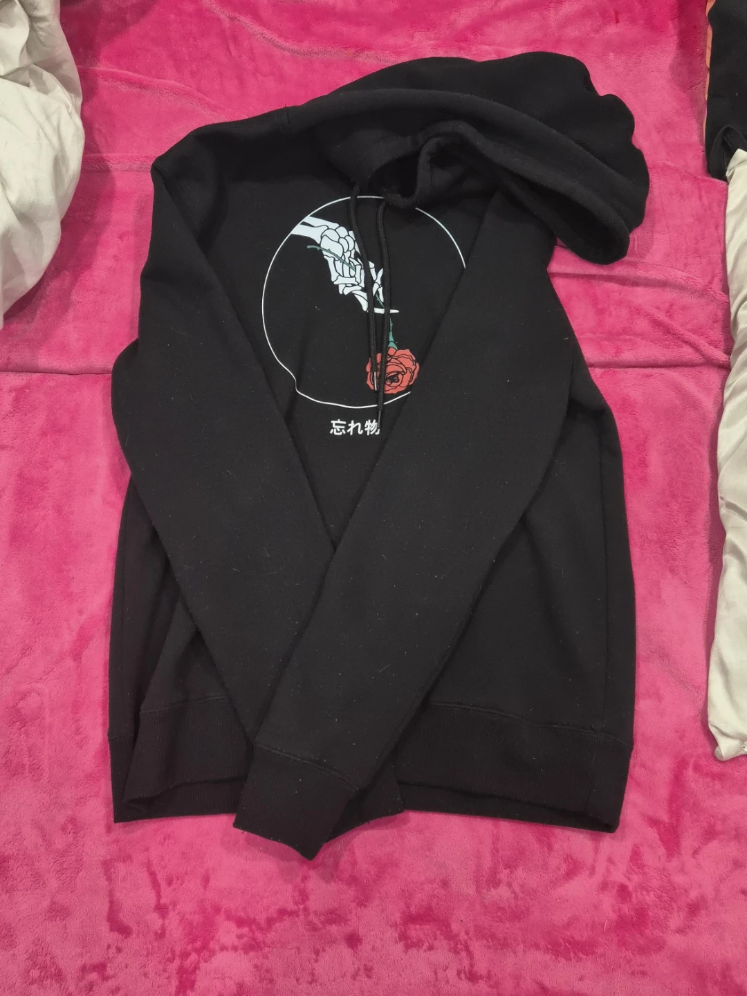 Black graphic hoodie with rose and skeleton hand design
