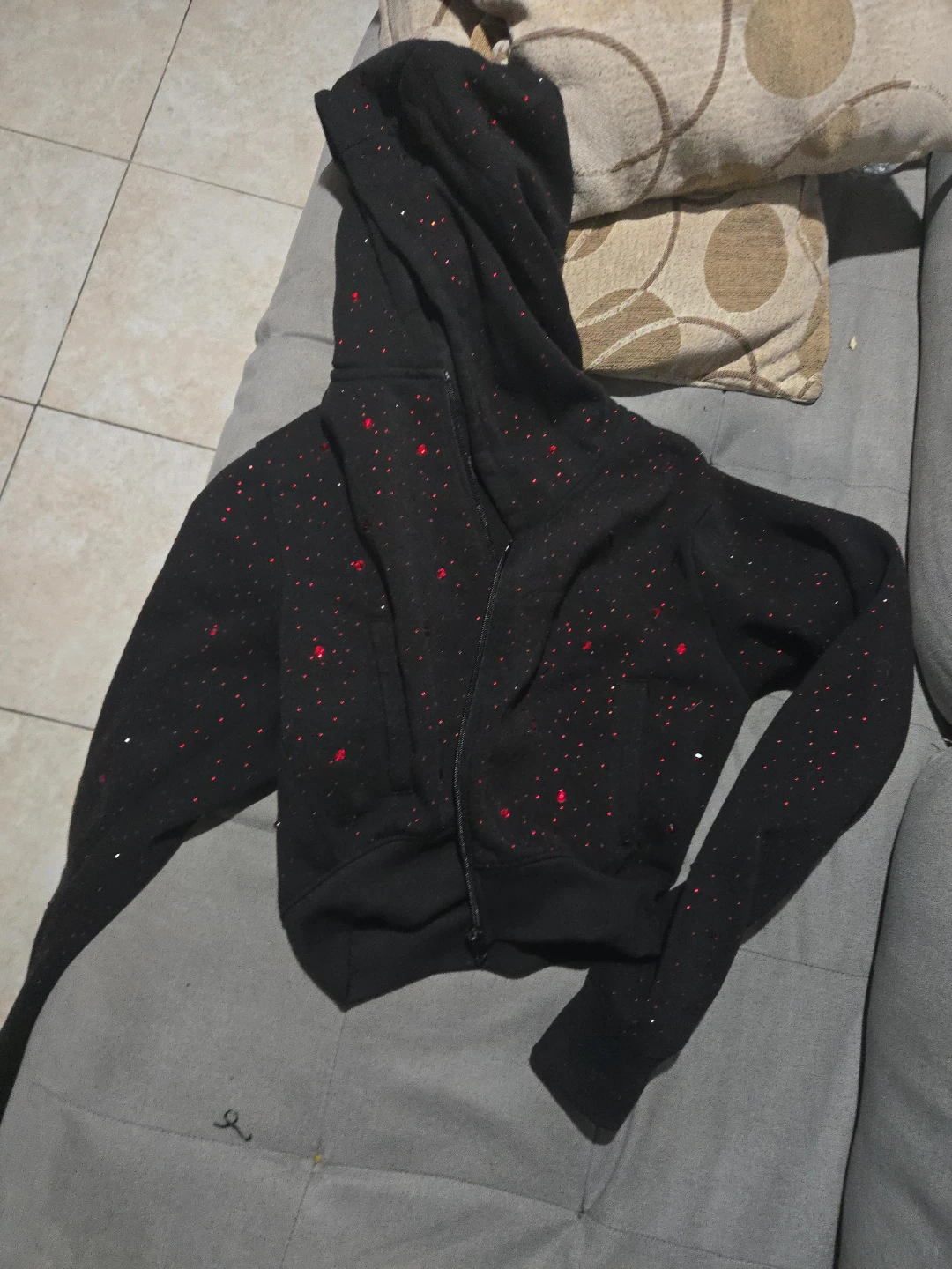 Black zip-up hoodie with red speckles