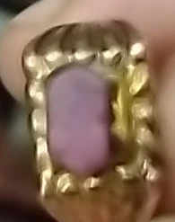 Gold-tone ring with purple stone
