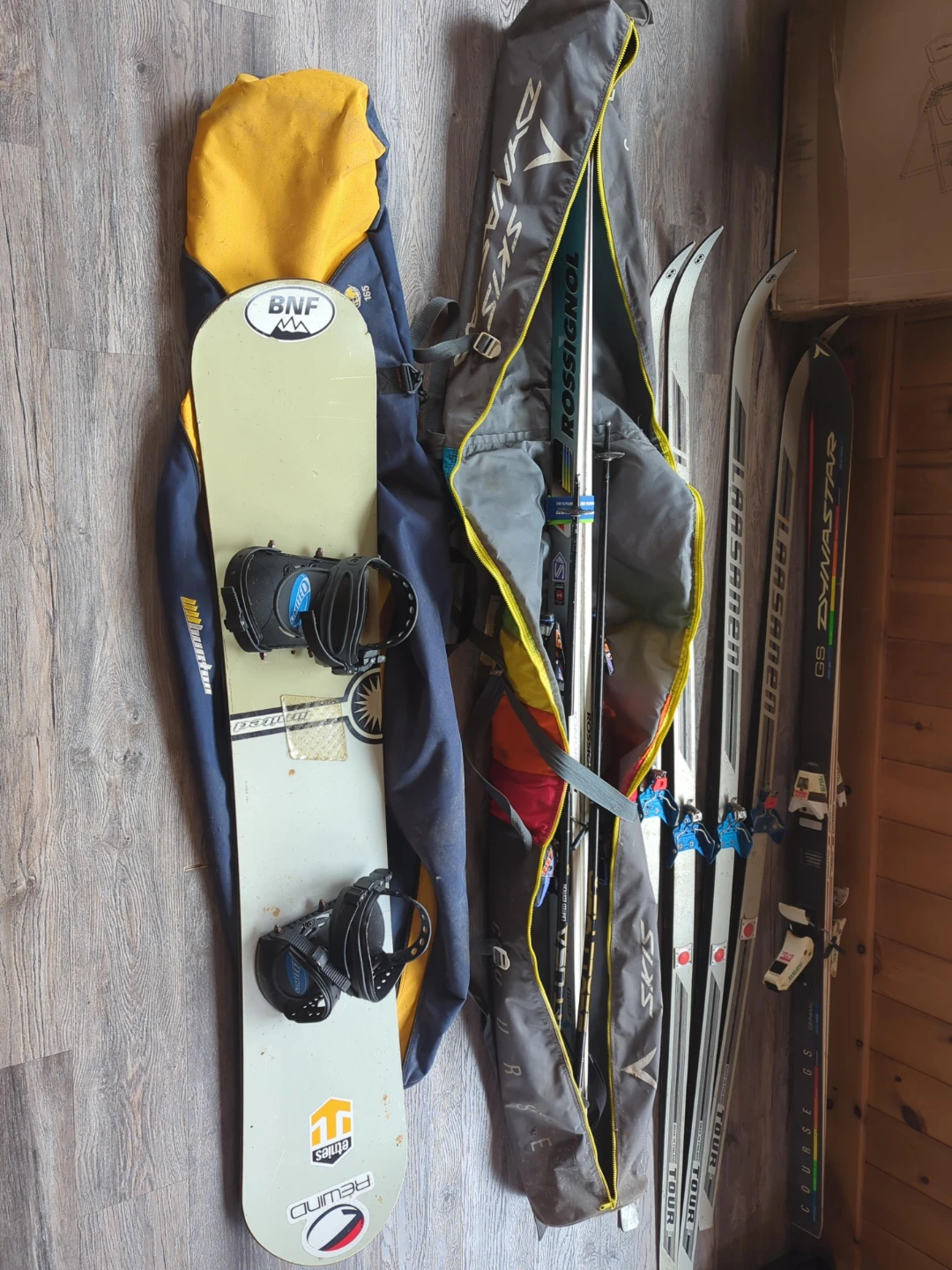 Cross-country skis and snowboard with bags