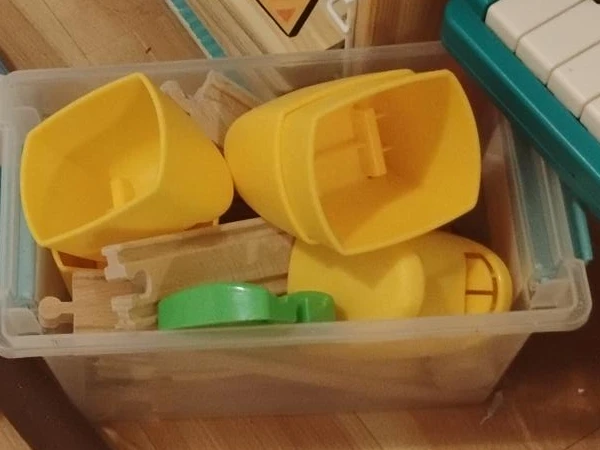Yellow Plastic Toy Funnels and Wooden Train Track Pieces