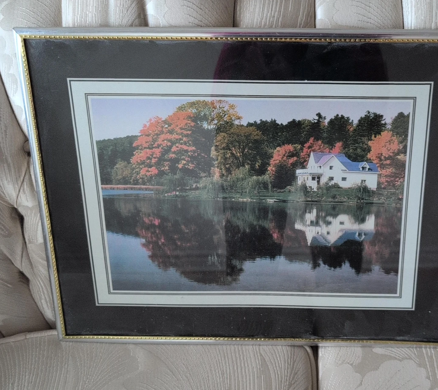 Framed Print of a House by a Lake in Autumn