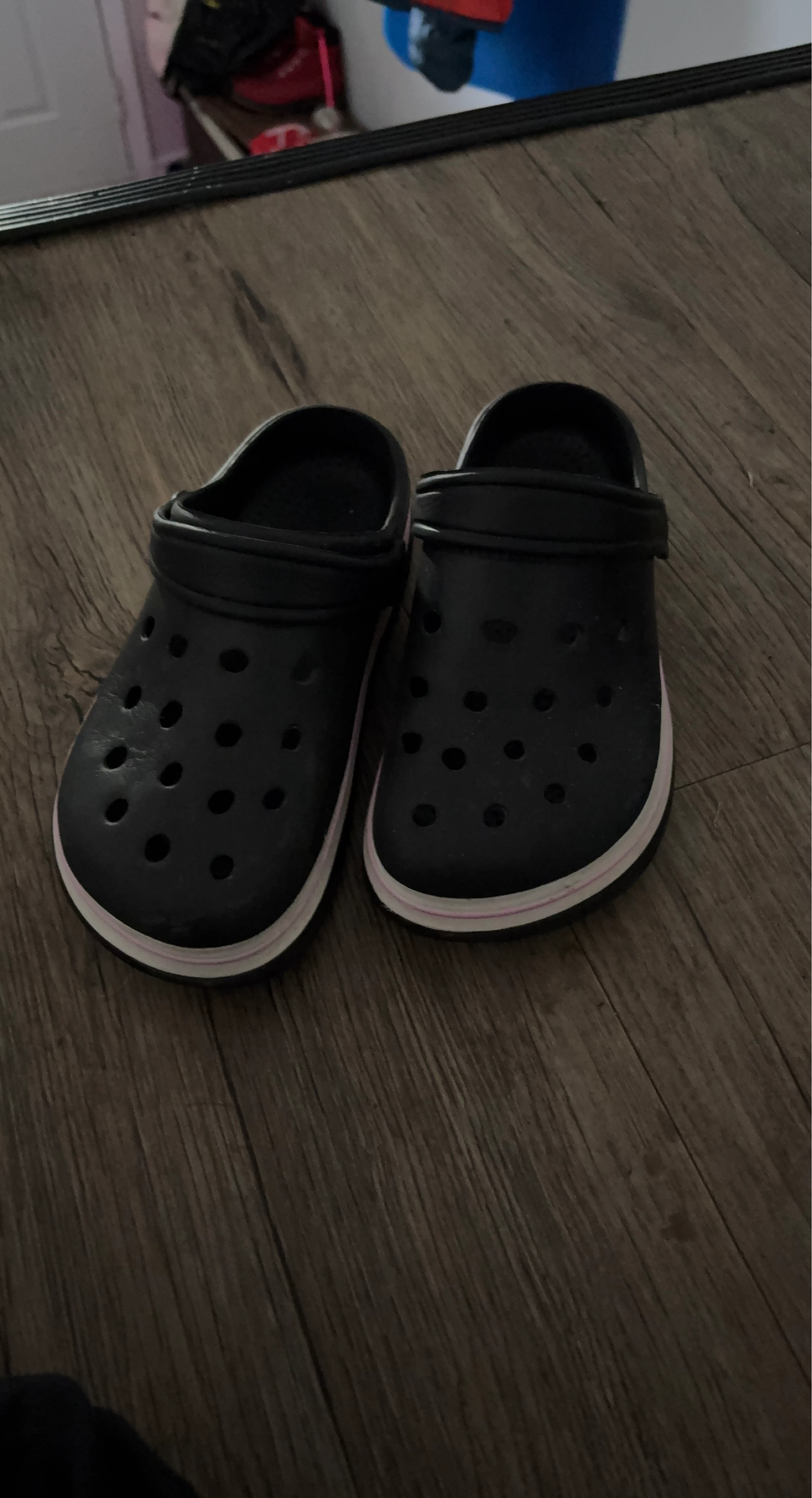 Black Crocs with pink and white stripe