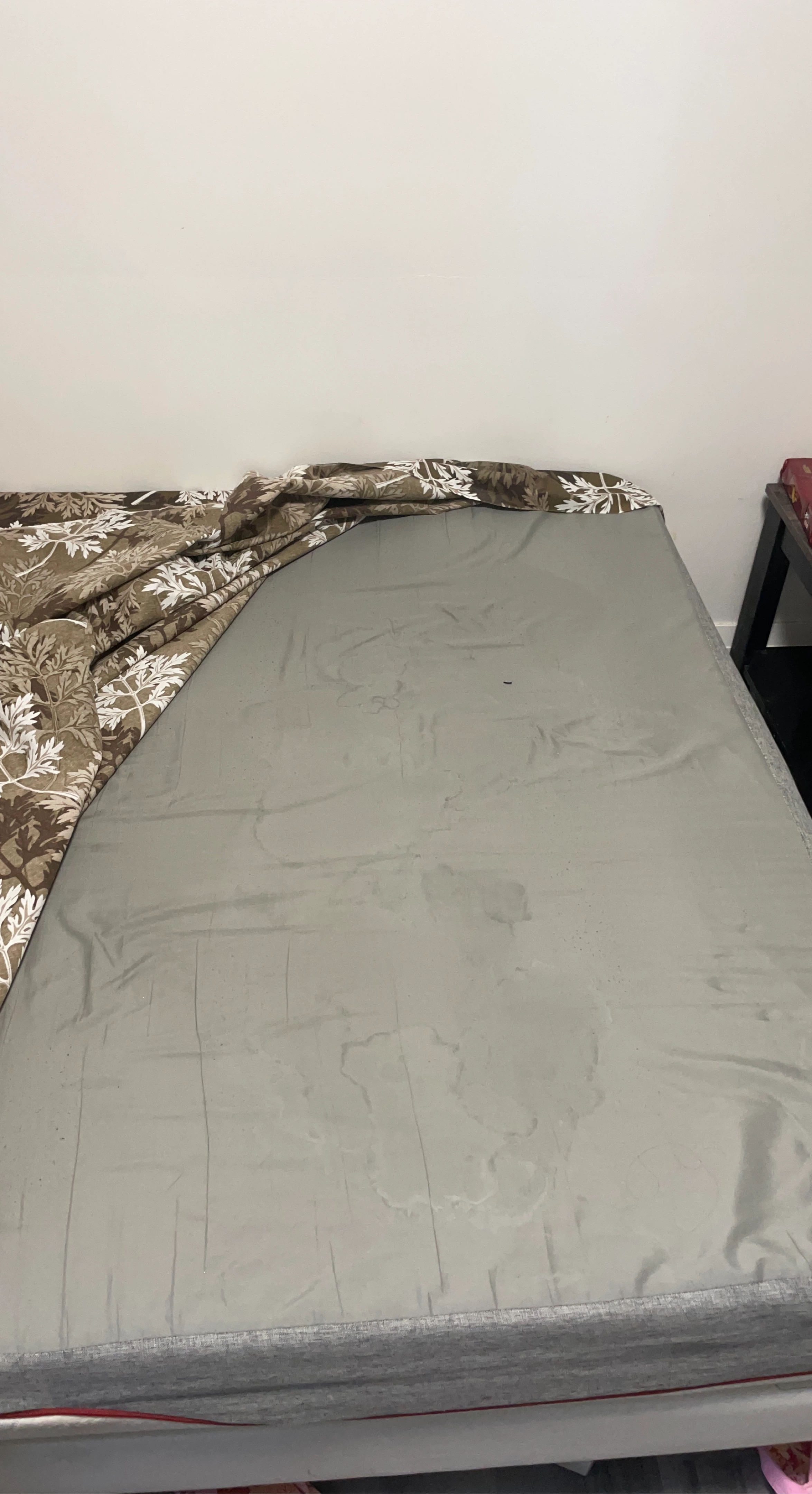 Grey mattress with patterned sheet