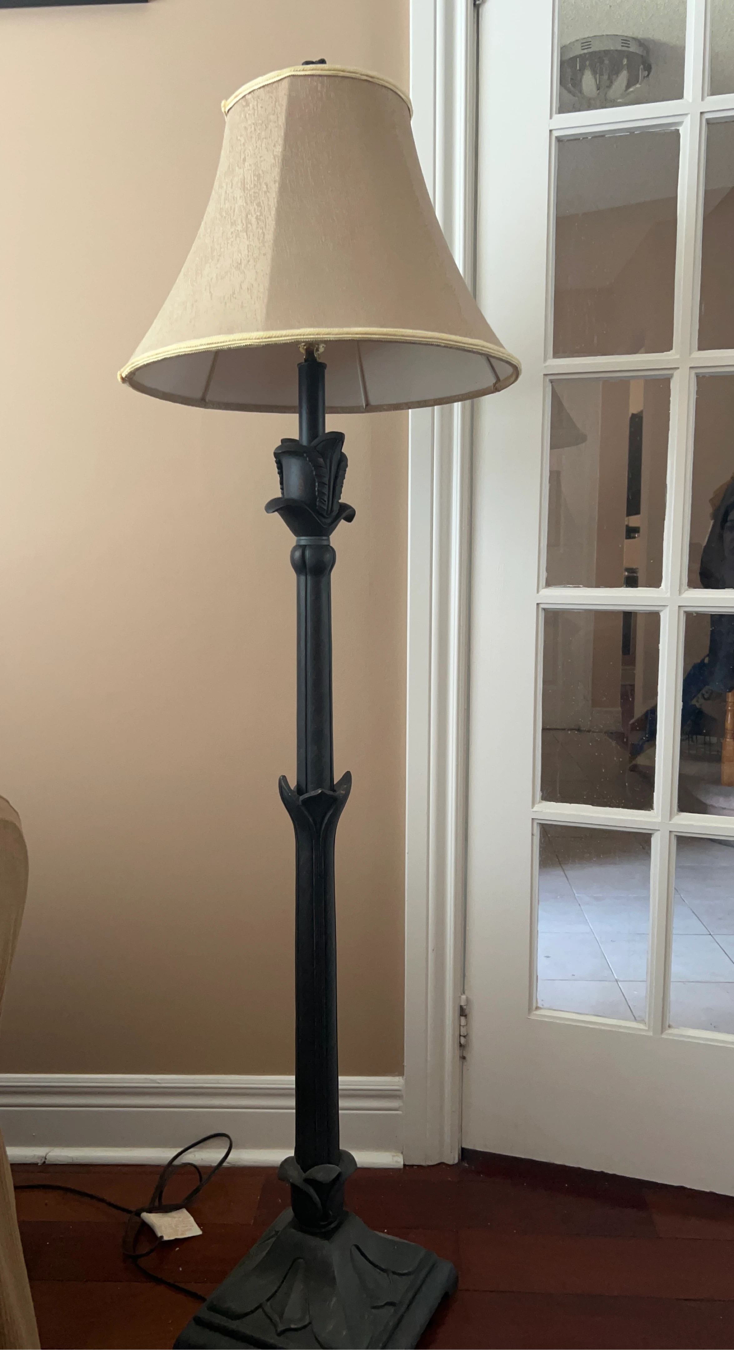 Black floor lamp with tan shade