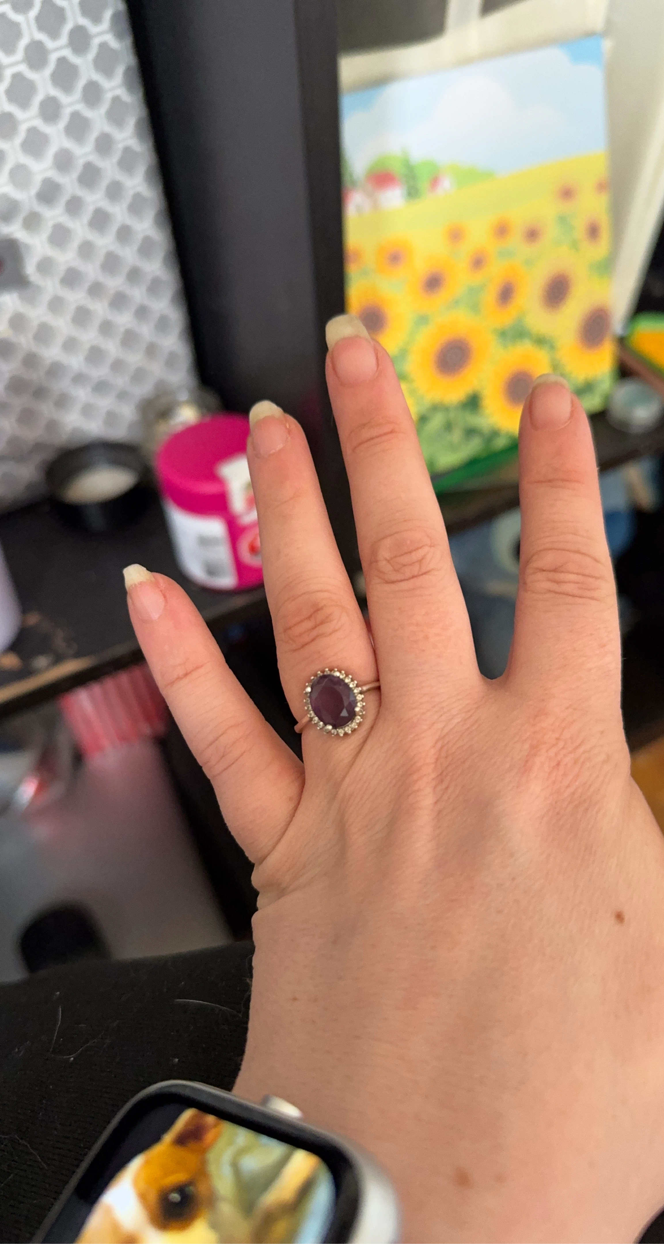 Oval deep purple gemstone ring with small clear stones