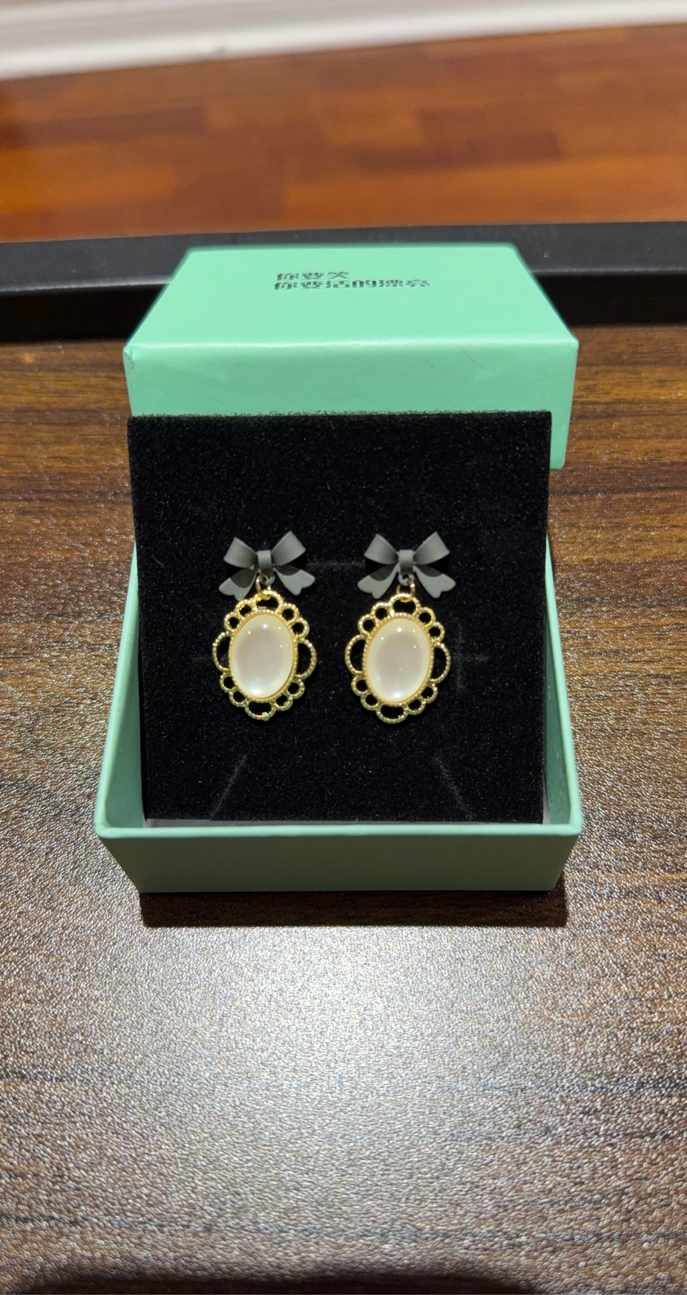 Gold Tone Oval Cameo Earrings with Grey Bow Accent