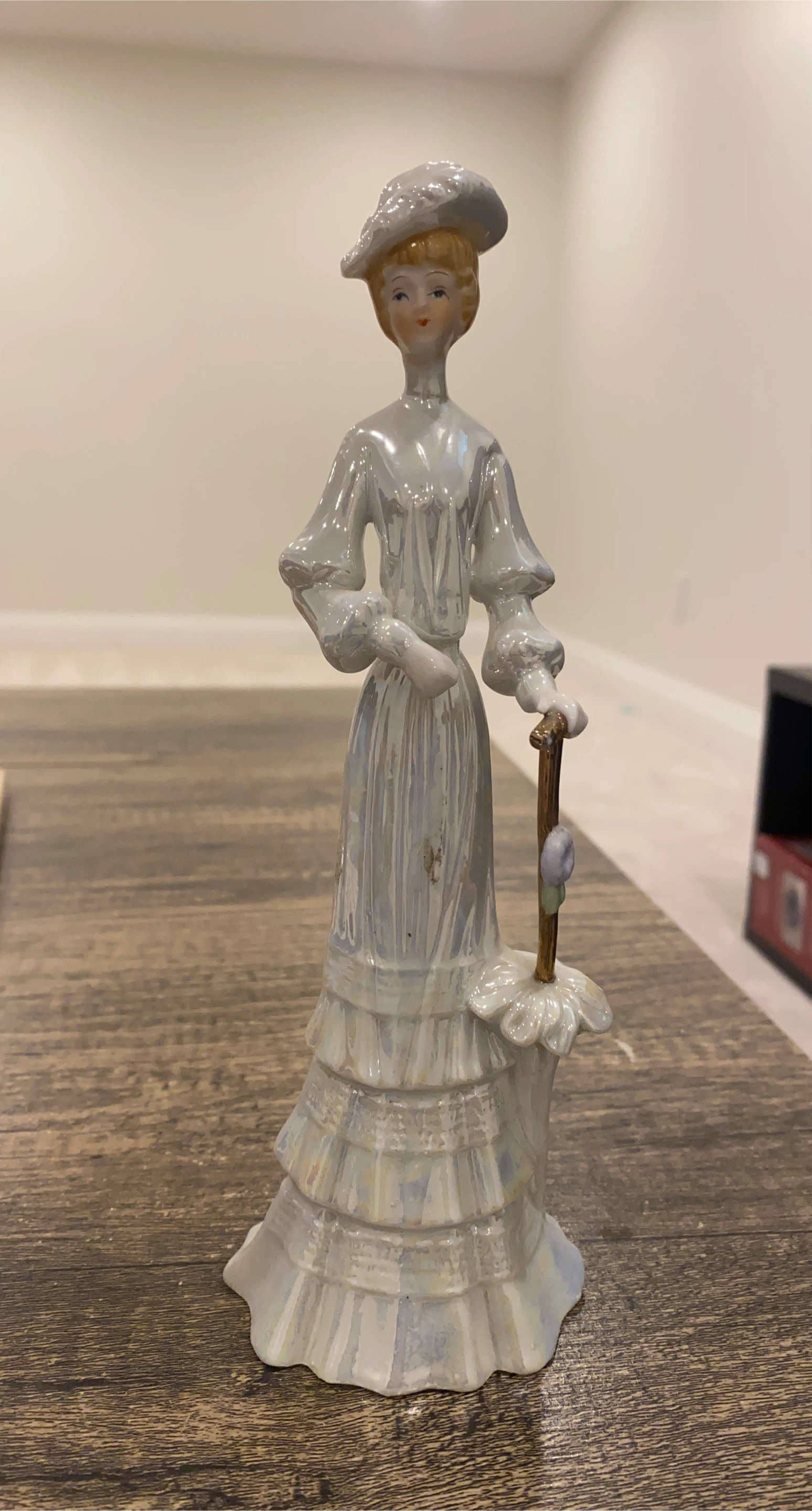 Porcelain Figurine of a Woman with a Cane