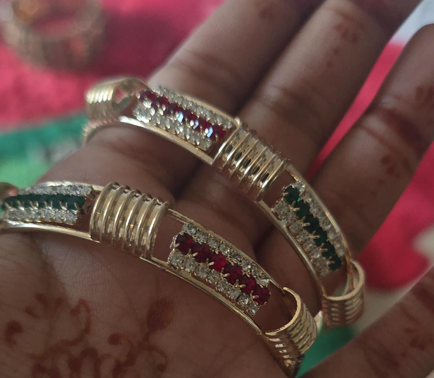 Gold-tone bangles with red and green stones