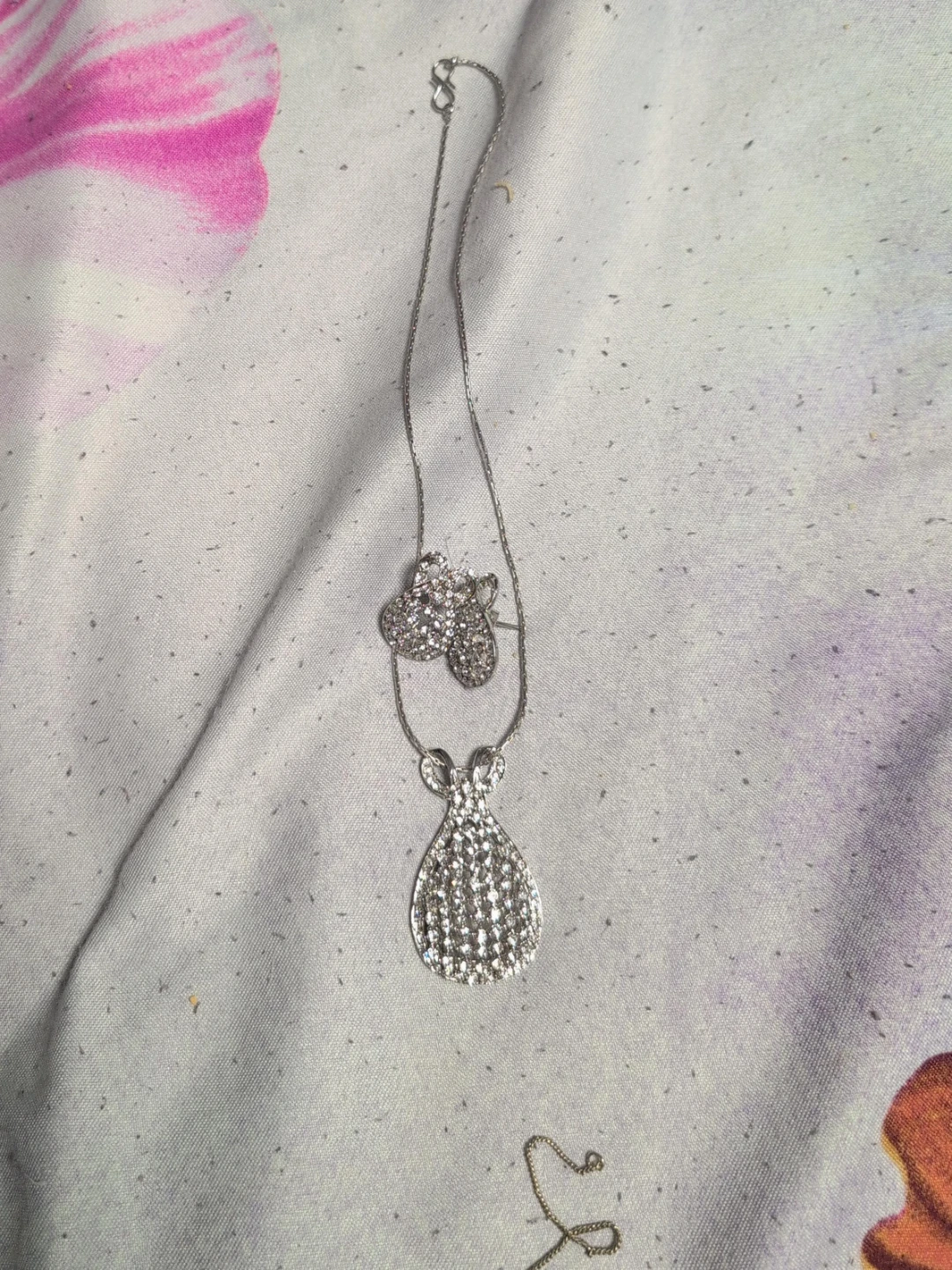 Silver-tone pendant necklace with butterfly and teardrop charms