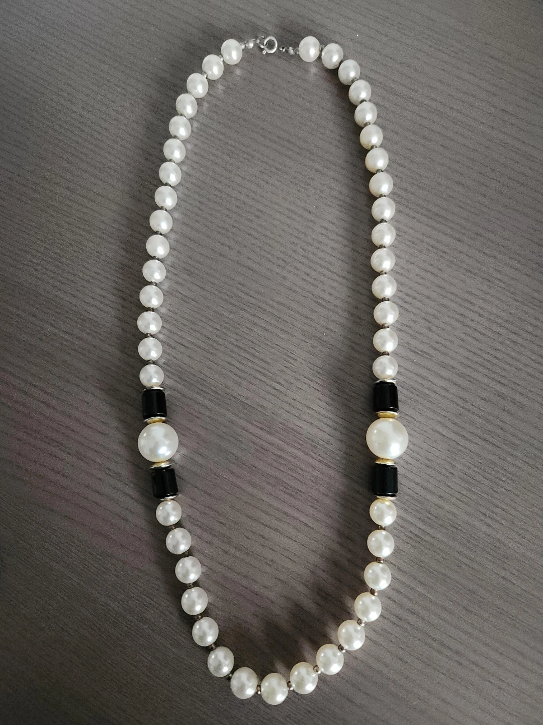 Pearl necklace with black and gold accents