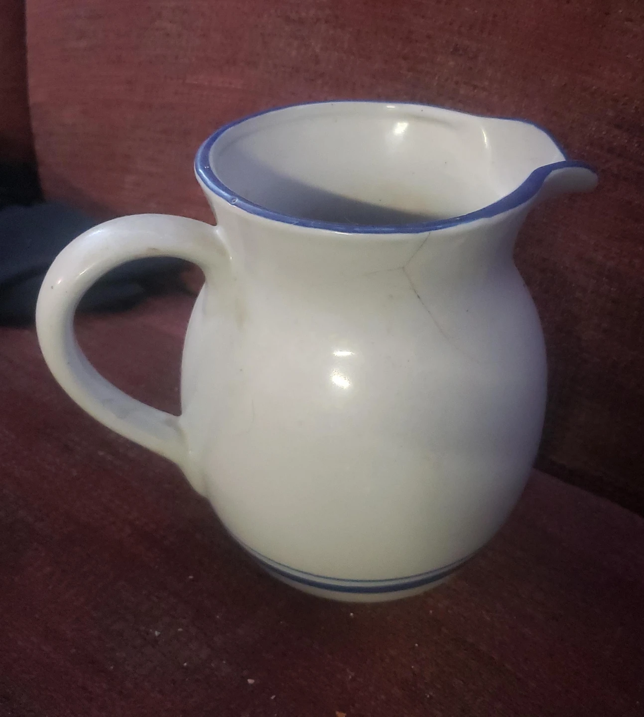 White Ceramic Pitcher with Blue Rim