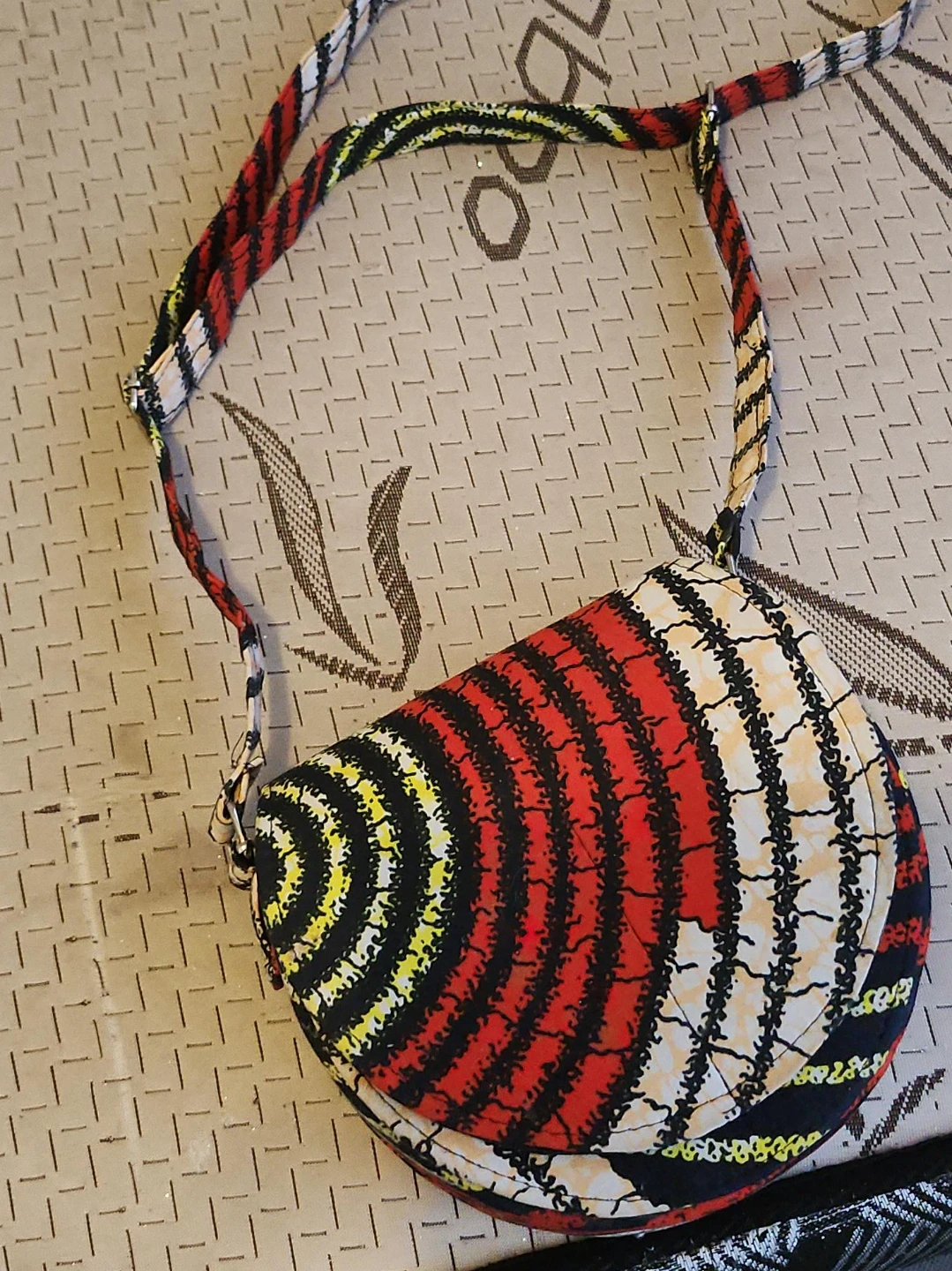 Round crossbody bag with vibrant print