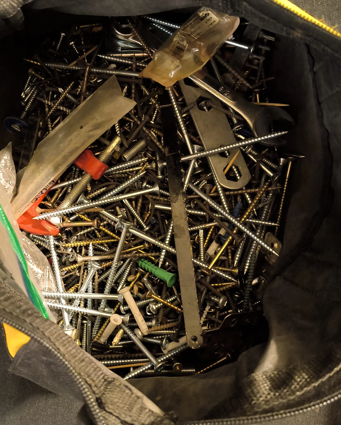 Assorted Screws, Nails, and Wall Anchors in Tool Bag