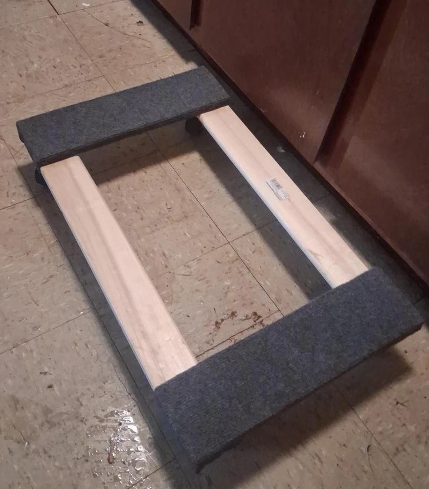 Wooden bed frame with grey upholstered supports