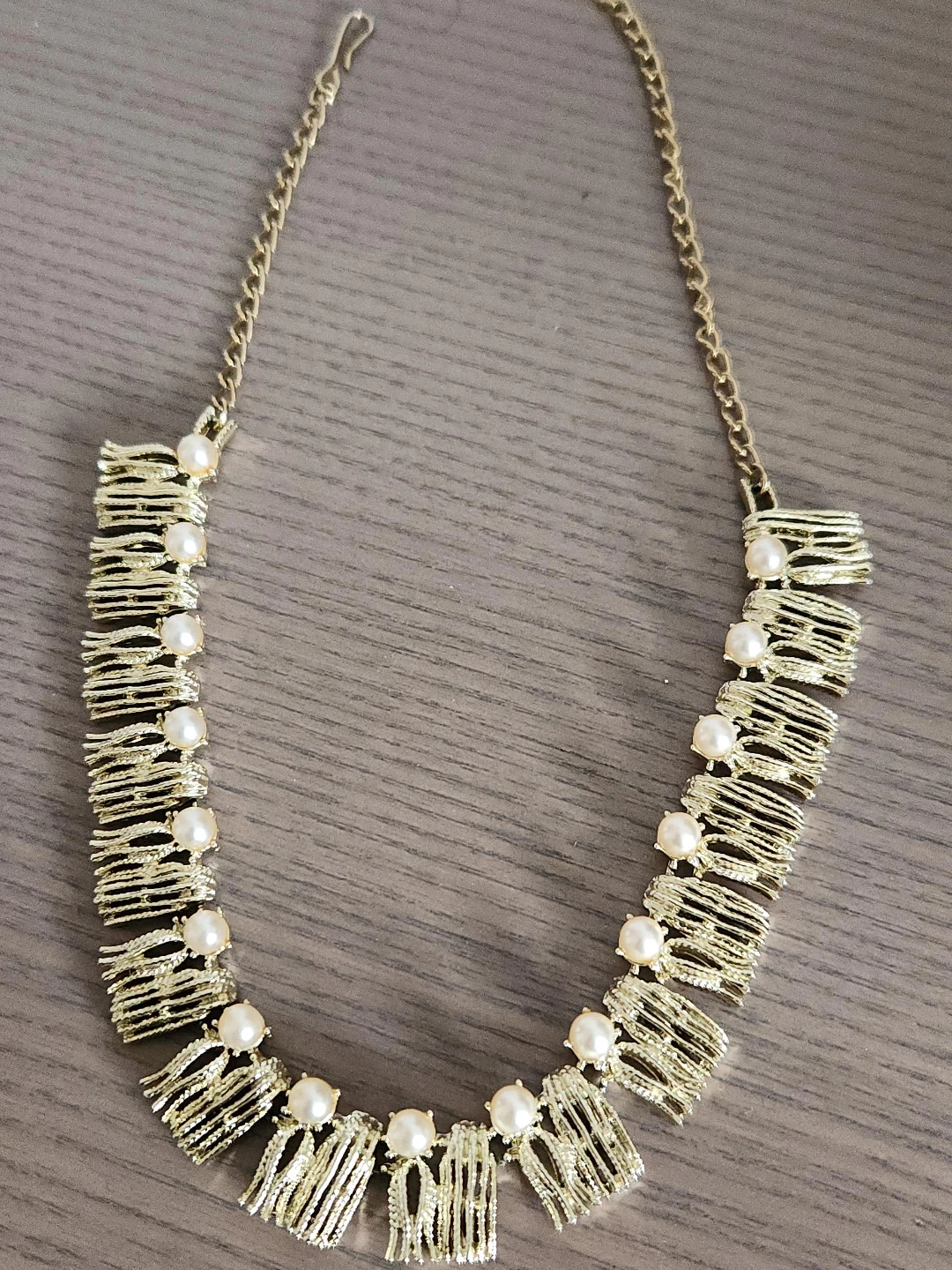 Gold tone statement necklace with pearl accents