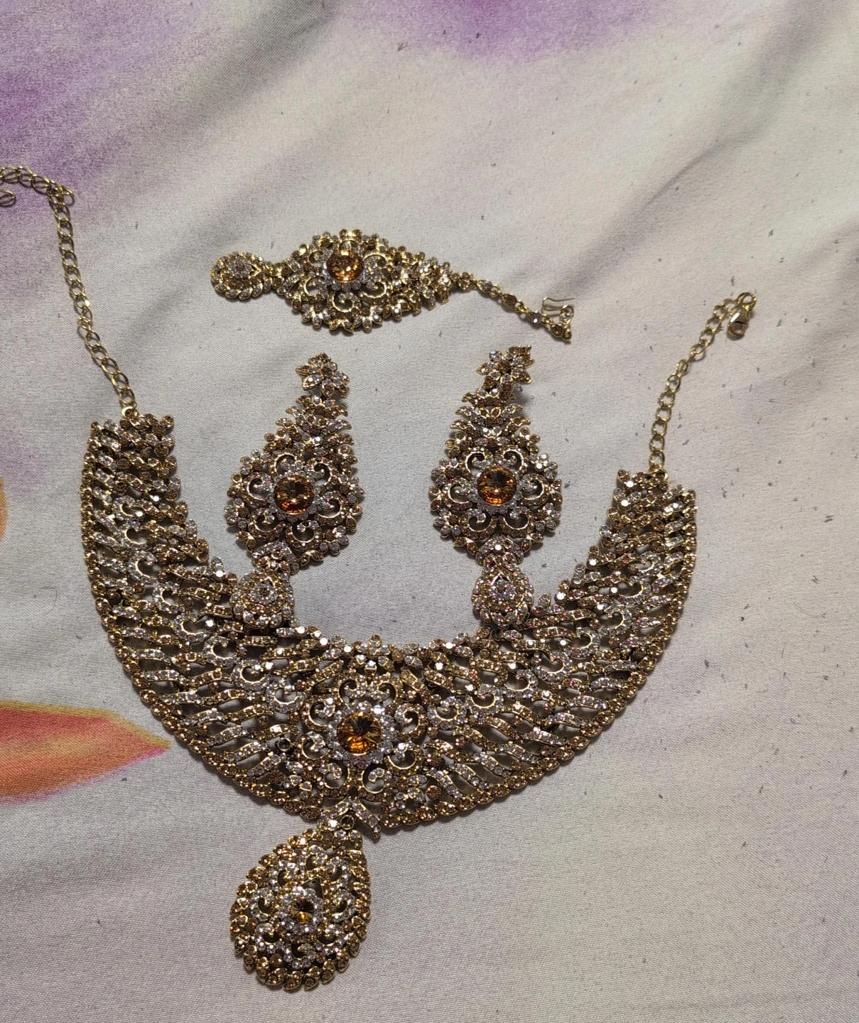 Gold-toned statement necklace and earring set with amber stones