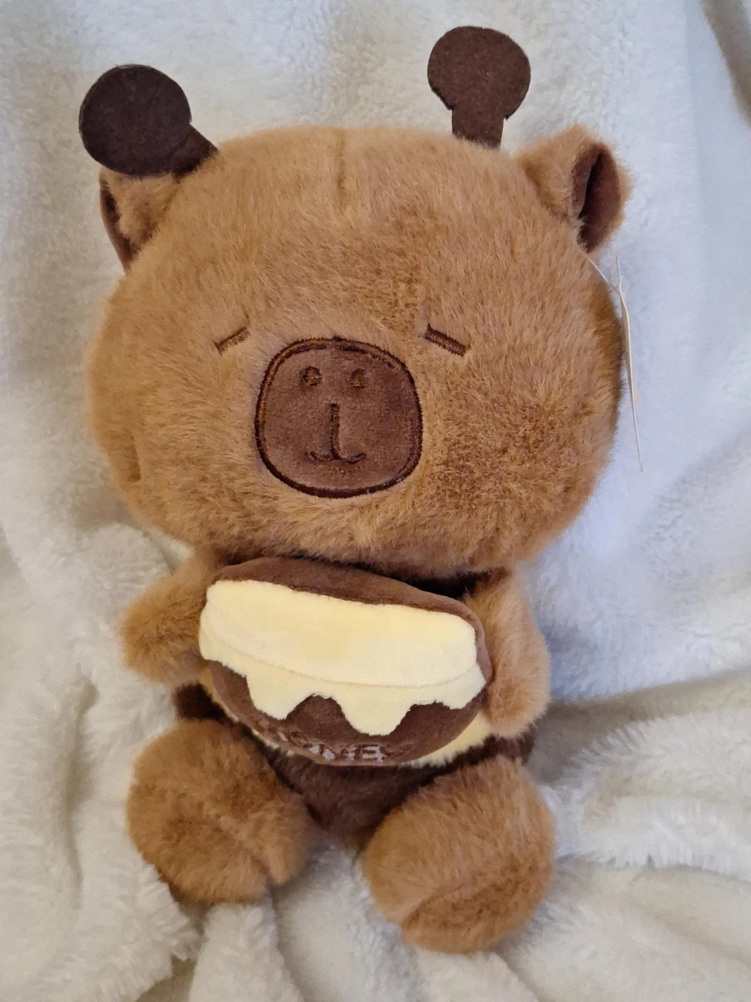 Brown bear plush toy with honey pot